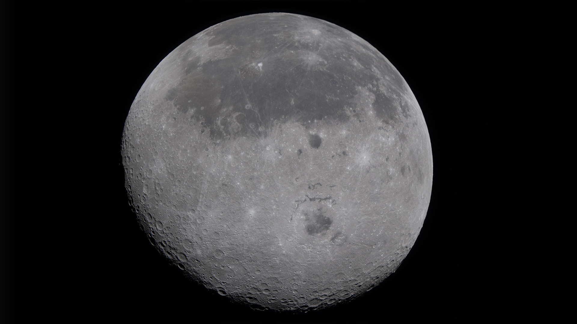 This image provided by NASA Monday, April 6, 2026, shows the Moon, the near side (the hemisphere we see from Earth) visible at the top half of the disk, identifiable by the dark splotches.