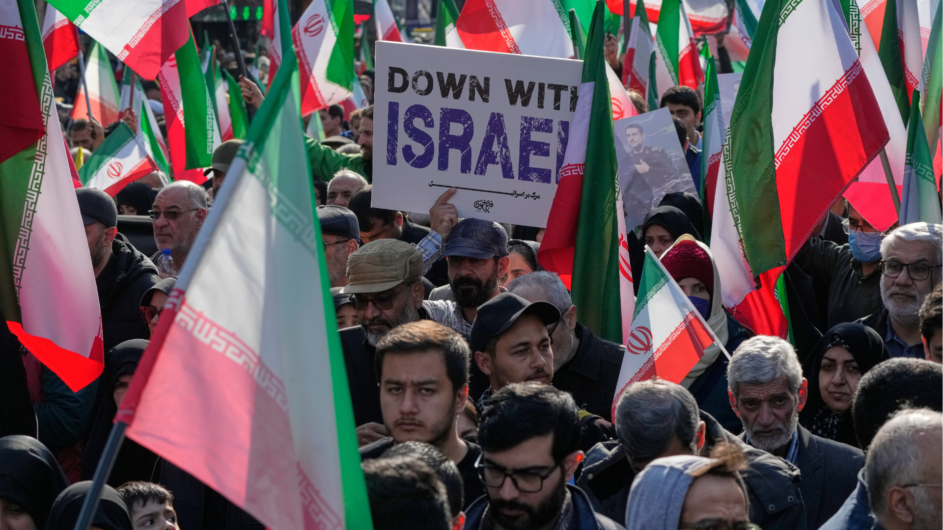 A man carries an anti-Israeli placard in Tehran, Iran, Wednesday, April 1, 2026, during a funeral procession.