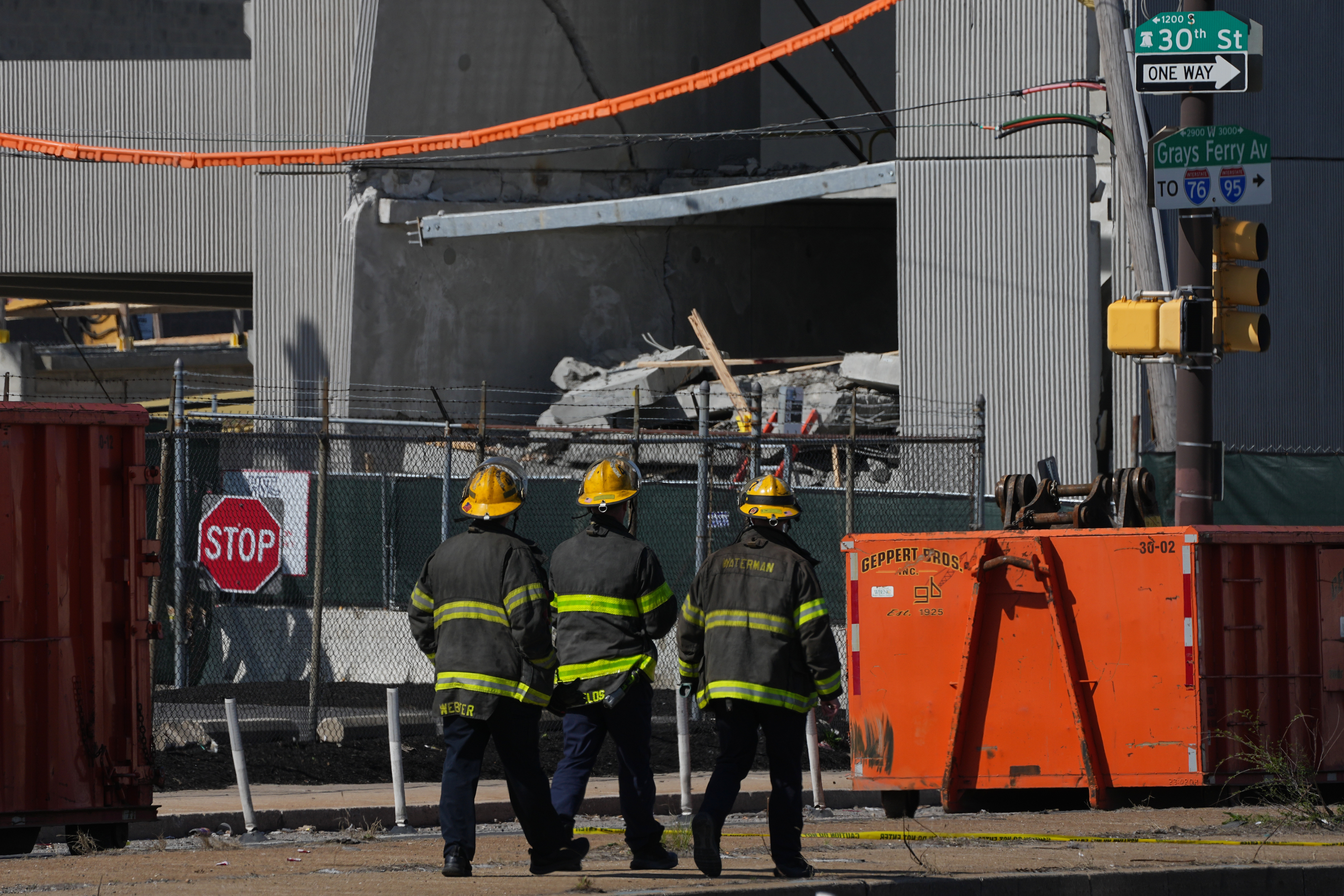 First responders walk near a partially collapsed parking garage in Philadelphia, Thursday, April 9, 2026.