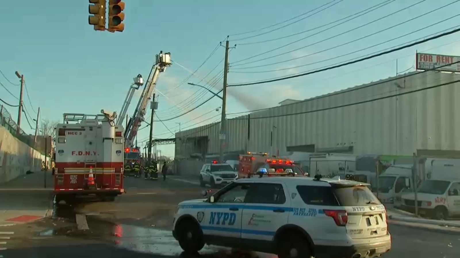 Firefighters working to put out hotspots after fire rips through warehouse in College Point