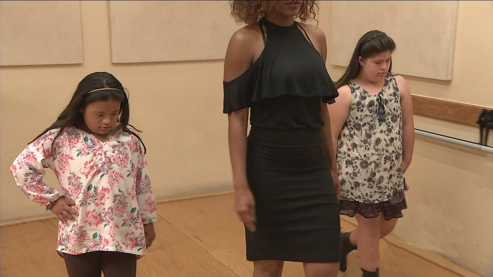 Girls with Down syndrome learn to walk runway in modeling class