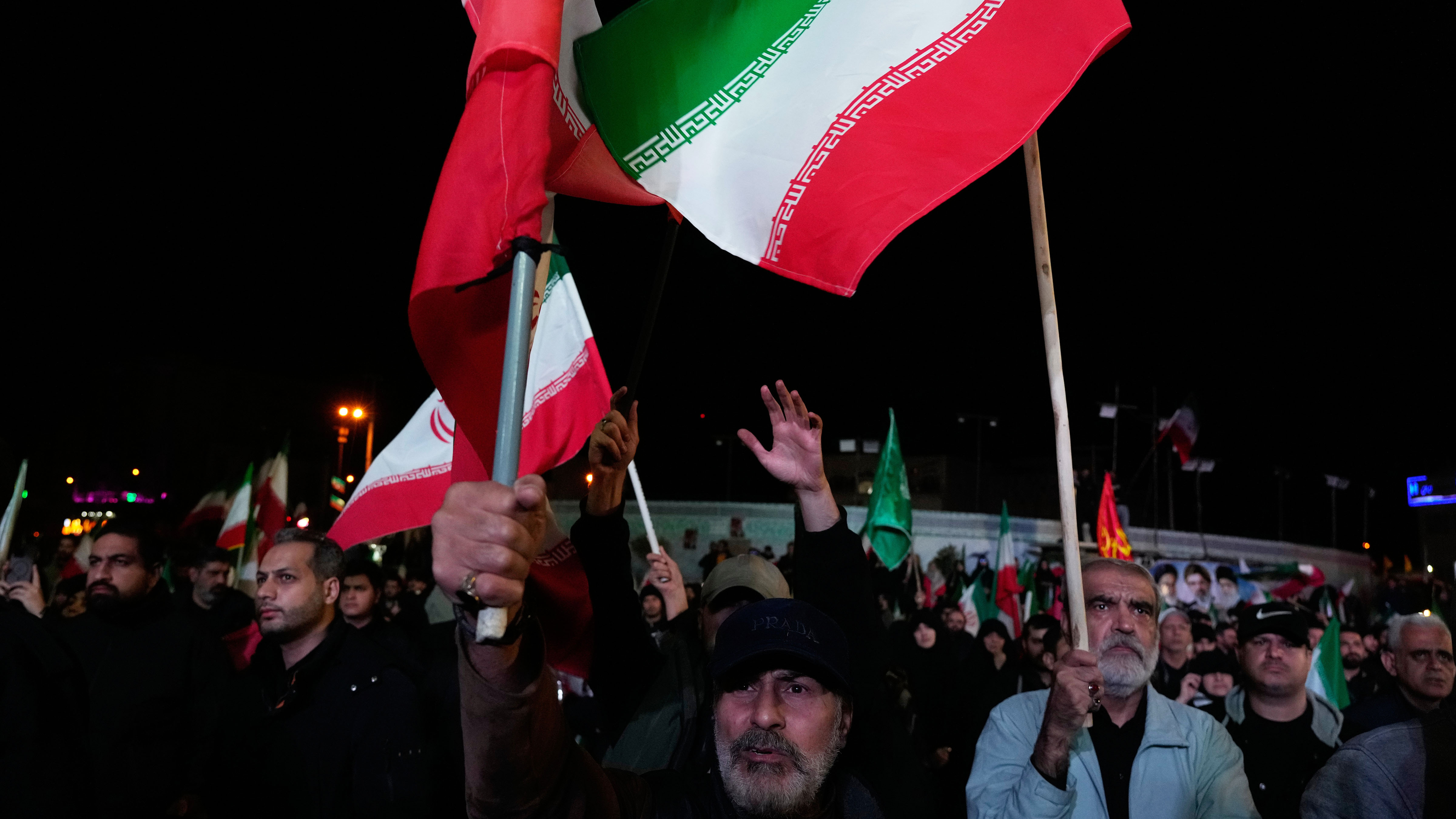 Iranian pro-government demonstrators wave their country's flags in a gathering after announcement of a two-week ceasefire in the war with the United States and Israel.