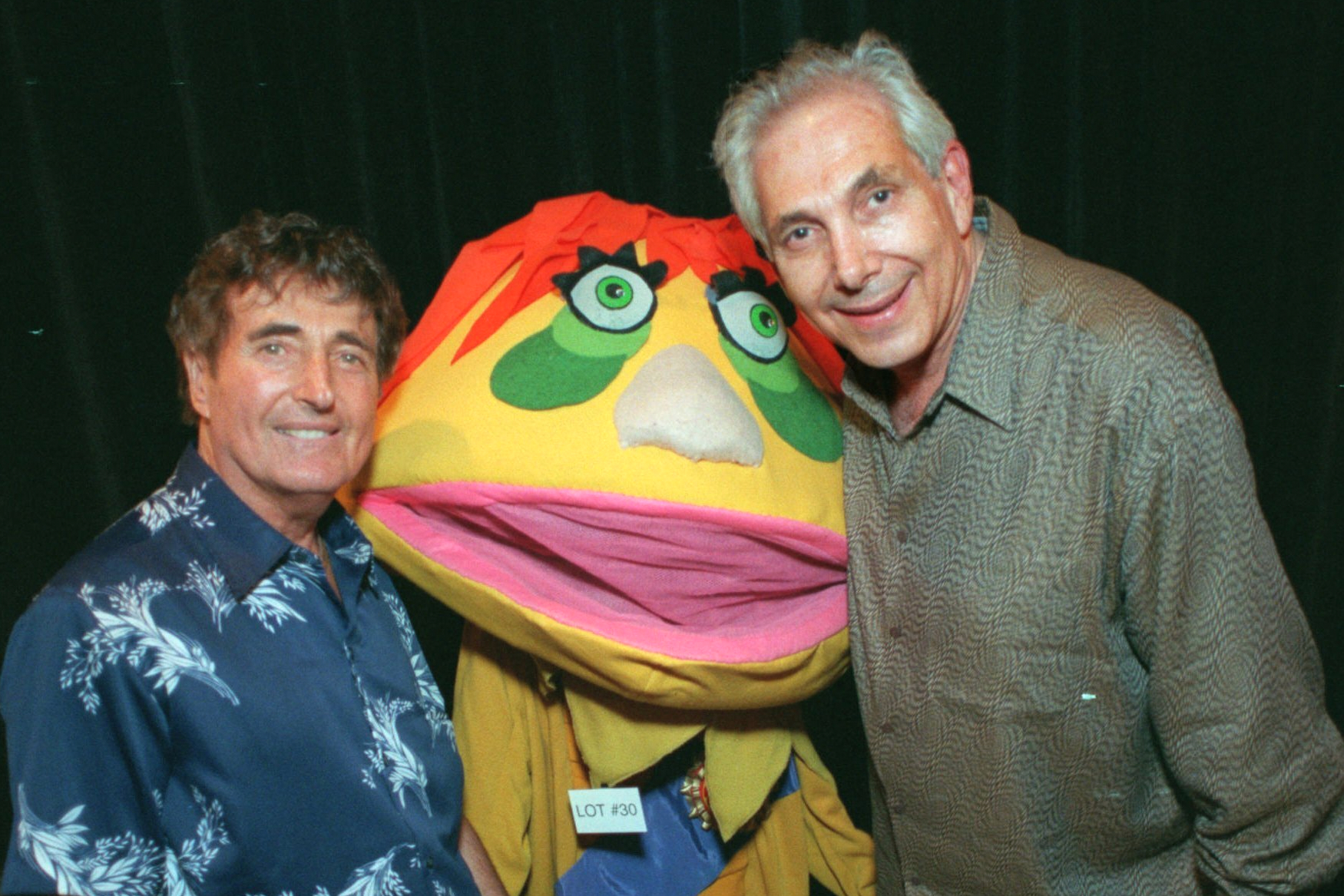 FILE - Puppeteers Sid Krofft, left, and Marty Krofft stand next to H.R. Pufnstuf, one of their many creations, at an auction in Beverly Hills, Calif., on Aug. 23, 1998.