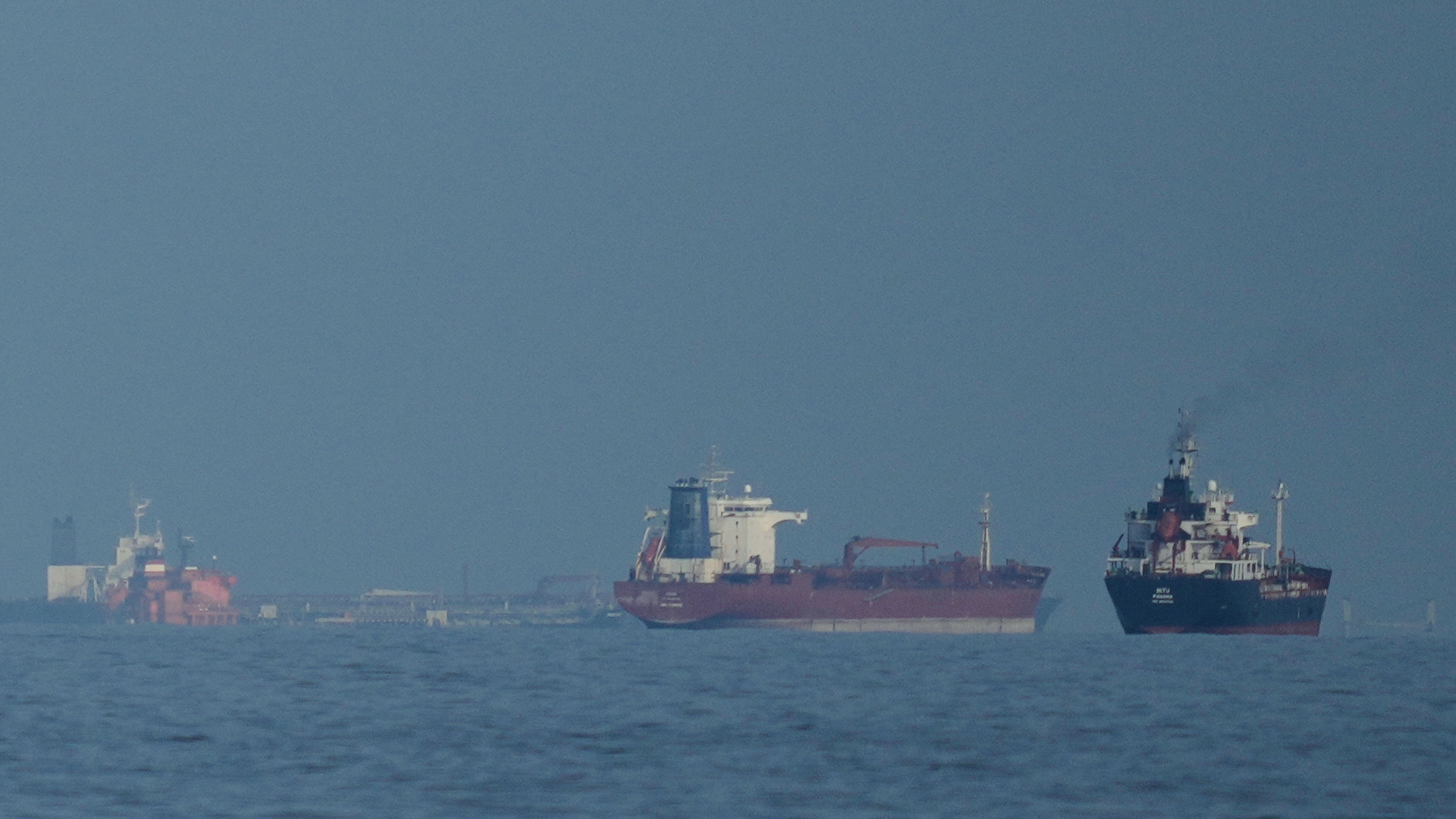 Oil tankers and cargo ships line up in the Strait of Hormuz as seen from Khor Fakkan, United Arab Emirates, Wednesday, March 11, 2026. 