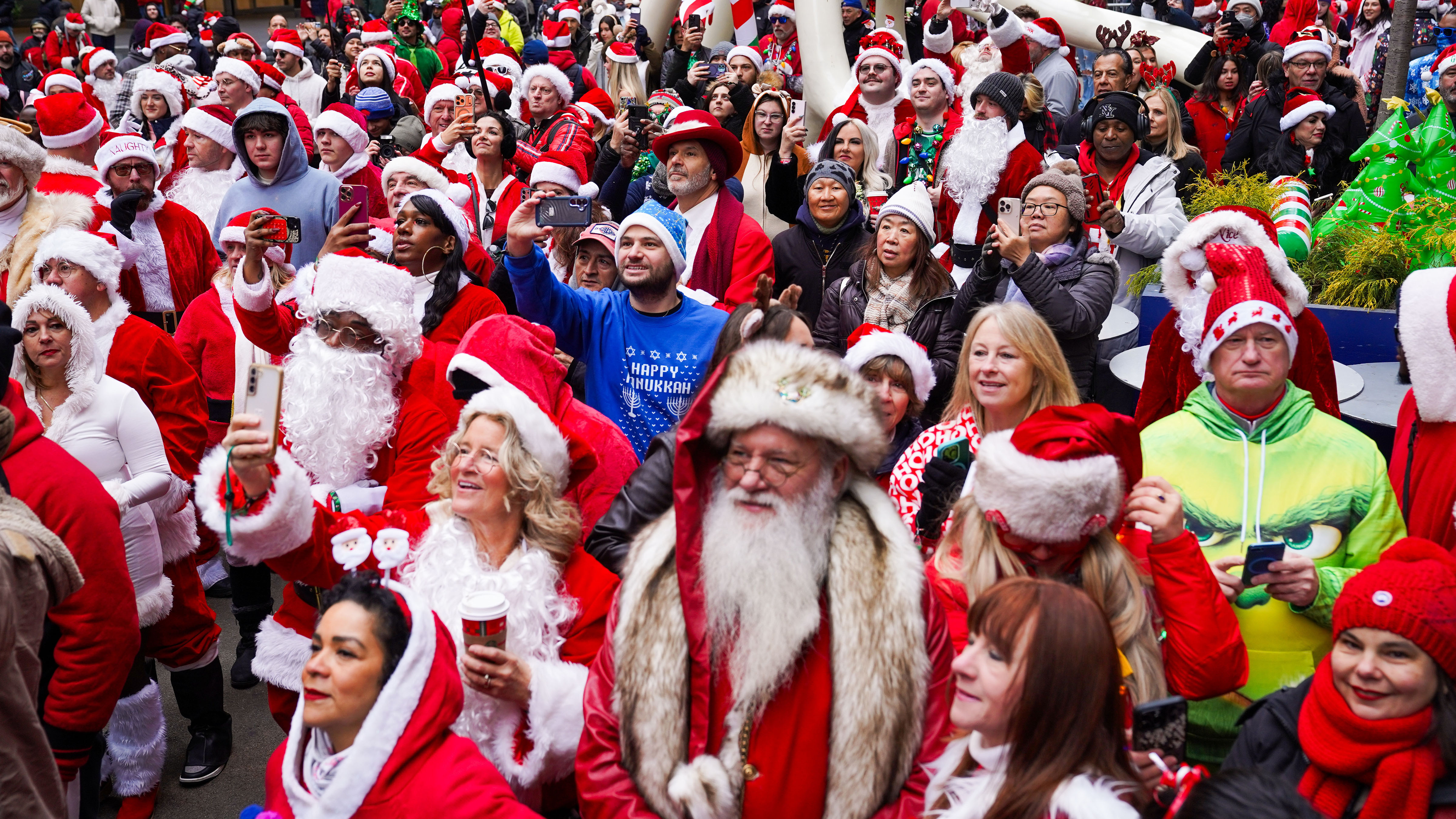 Revelers dressed as holiday characters participate in the annual SantaCon pub crawl in New York, on Saturday, Dec. 13, 2025. 