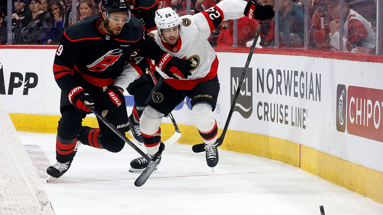 Hurricanes defenseman K'Andre Miller and Ottawa's Dylan Cozens chase the puck during the third period of Game 2 on Monday in Raleigh.