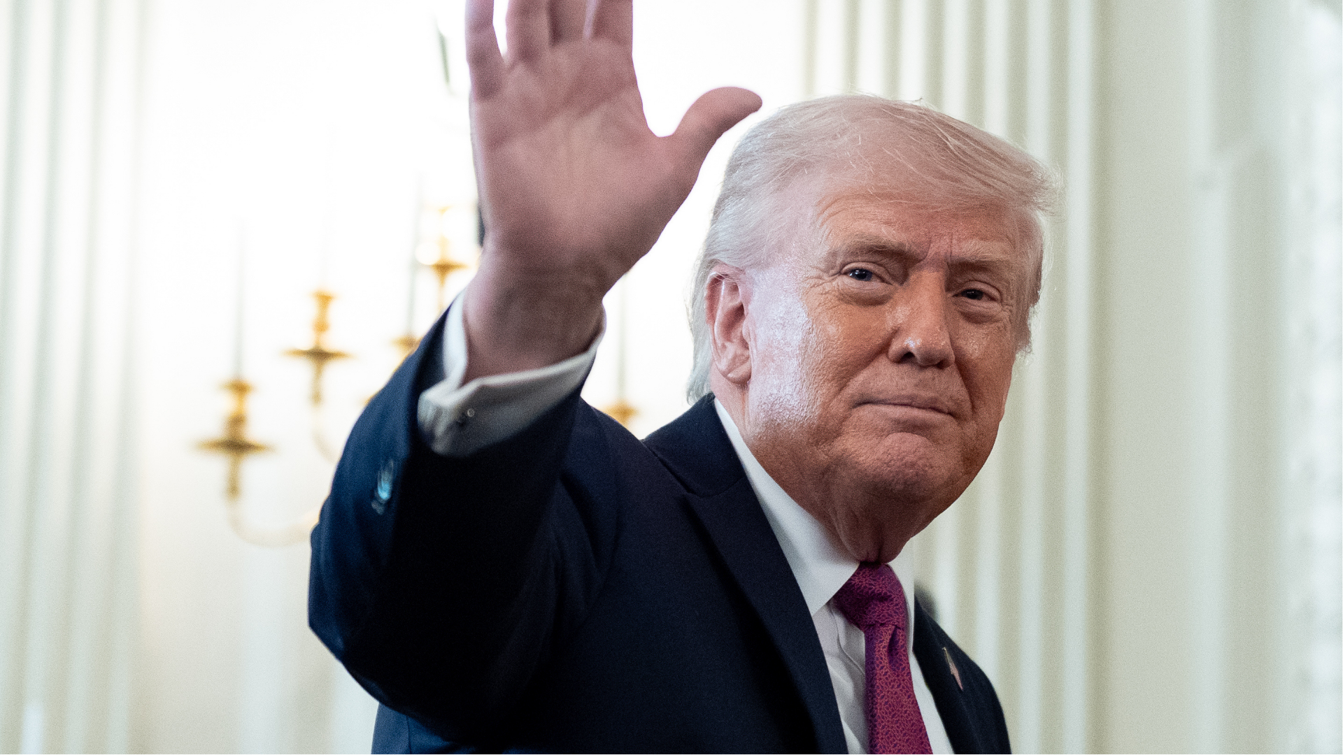 President Donald Trump waves as he departs after an event for NCAA national champions in the State Dining Room of the White House, Tuesday, April 21, 2026, in Washington.