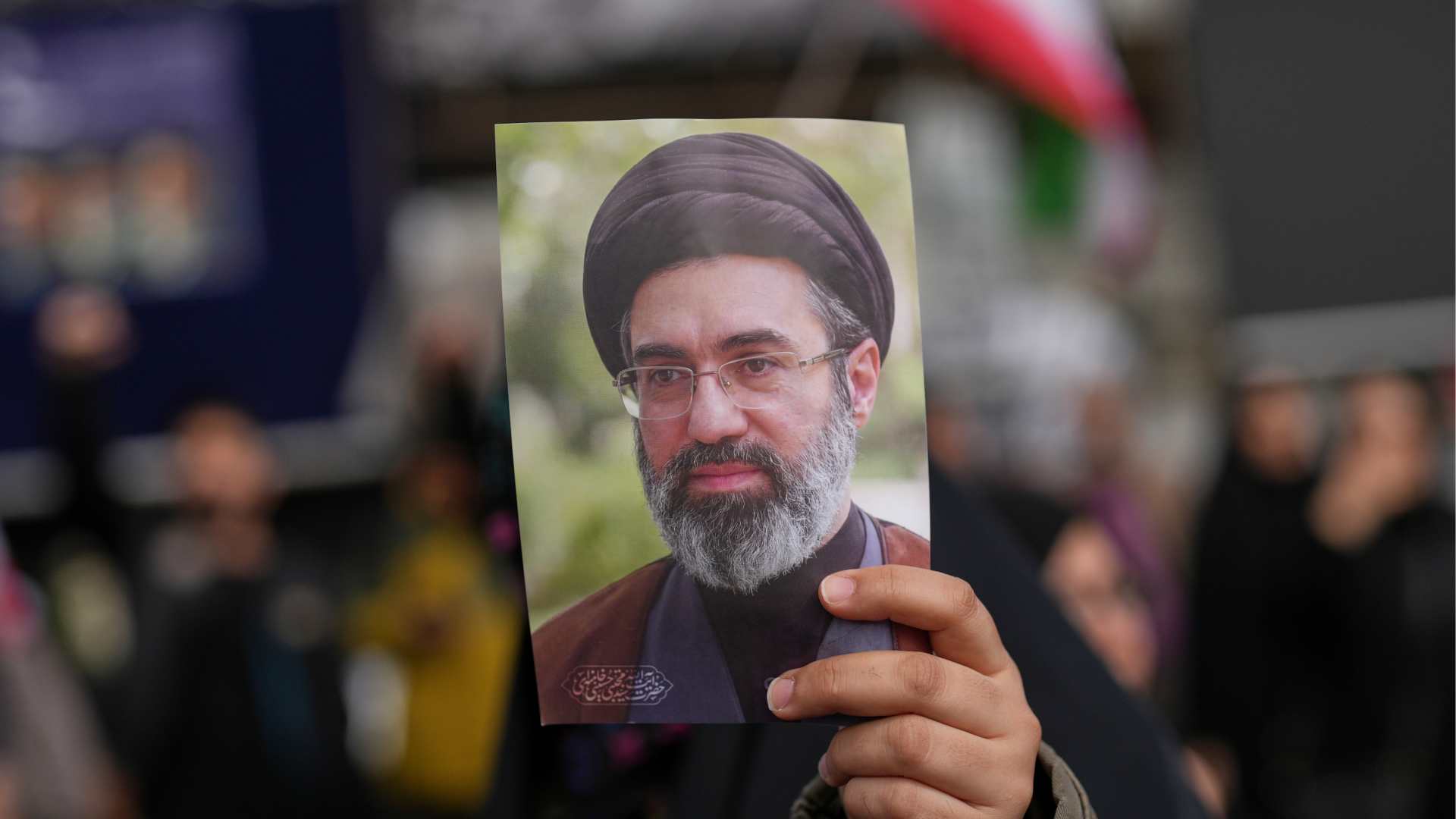 A demonstrator holds a picture of Iran's Supreme Leader Mojtaba Khamenei during a gathering after announcement of a two-week ceasefire with the United States and Israel, in Tehran, Iran, Wednesday, April 8, 2026.