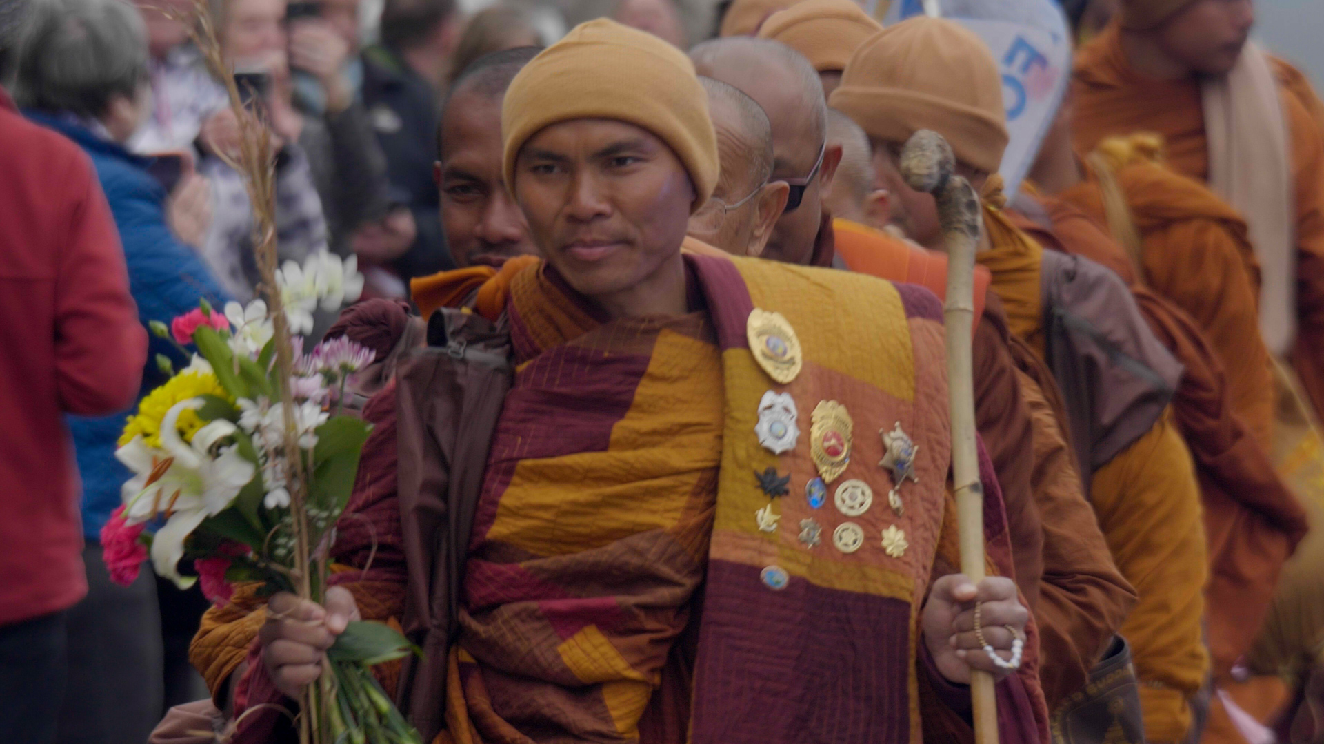 Venerable Bhikkhu Paññākāra leads the procession during the Walk for Peace, emerging as its most recognizable voice and figure along the route.