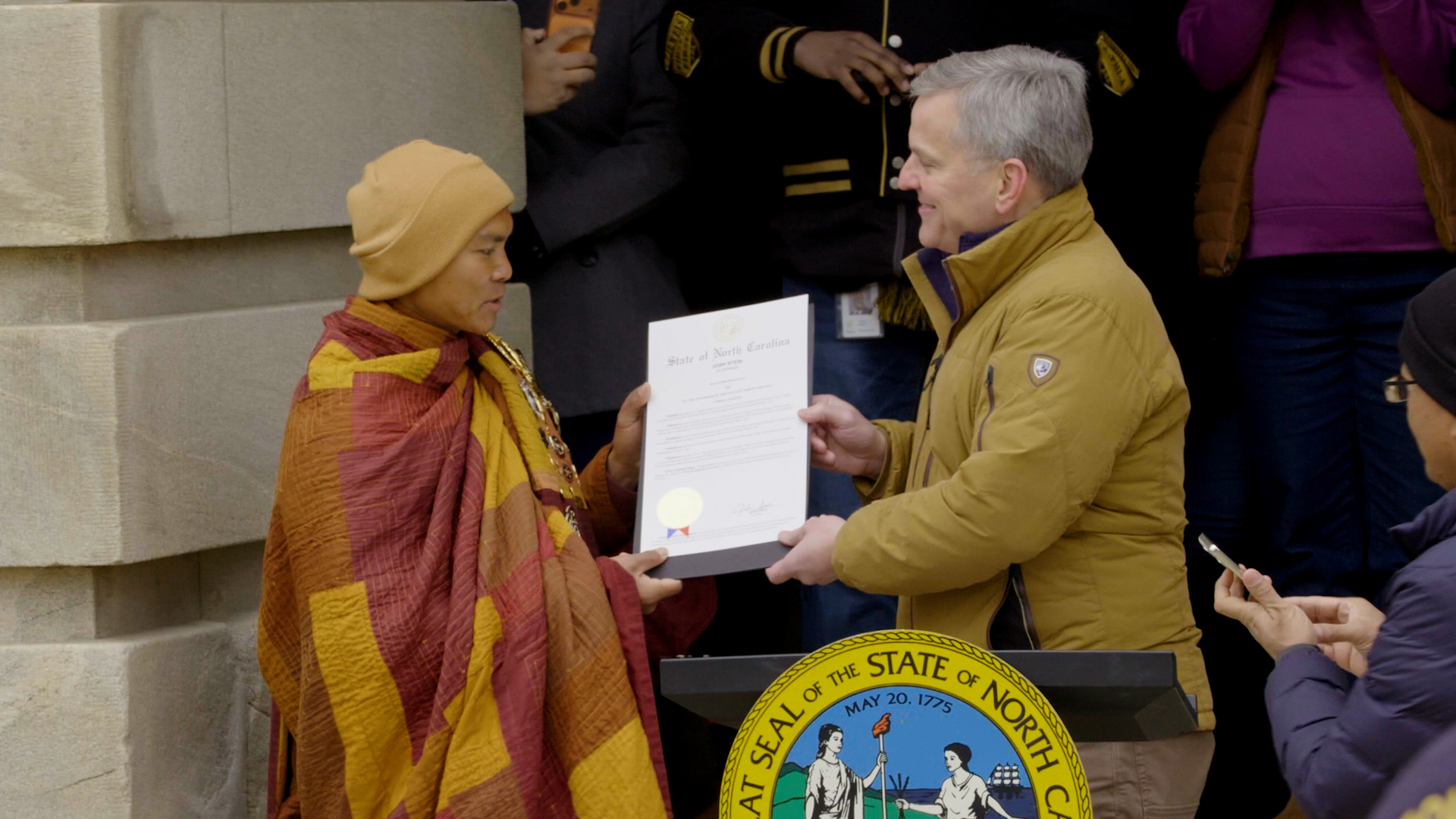 Gov. Josh Stein presents Venerable Bhikkhu Paññākāra with a proclamation declaring Jan. 24 as Walk for Peace Day at the North Carolina Capitol in Raleigh.