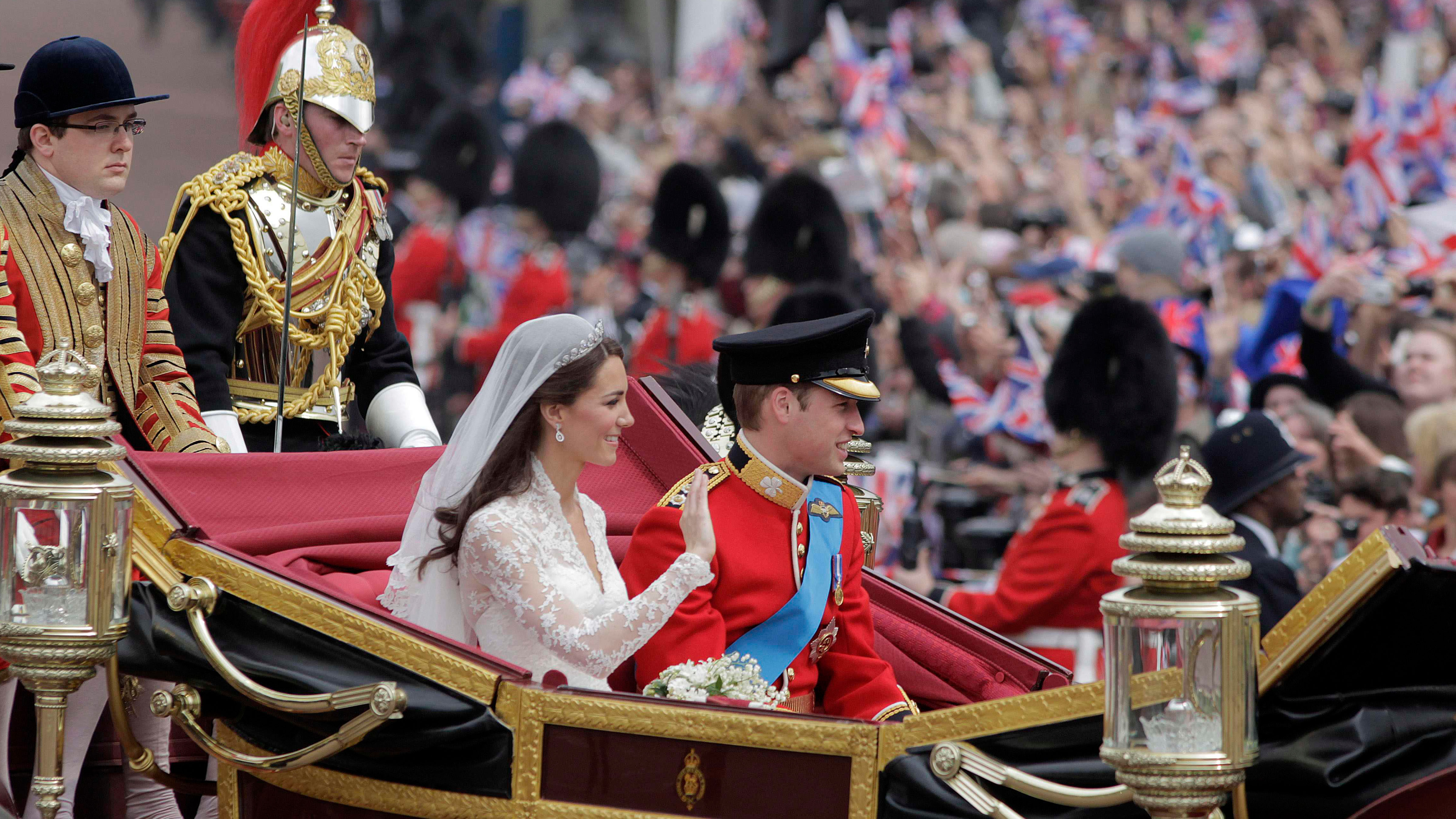 Britain's Prince William and his wife Kate, Duchess of Cambridge, make their way to Buckingham Palace after the royal wedding in London, April, 29, 2011.
