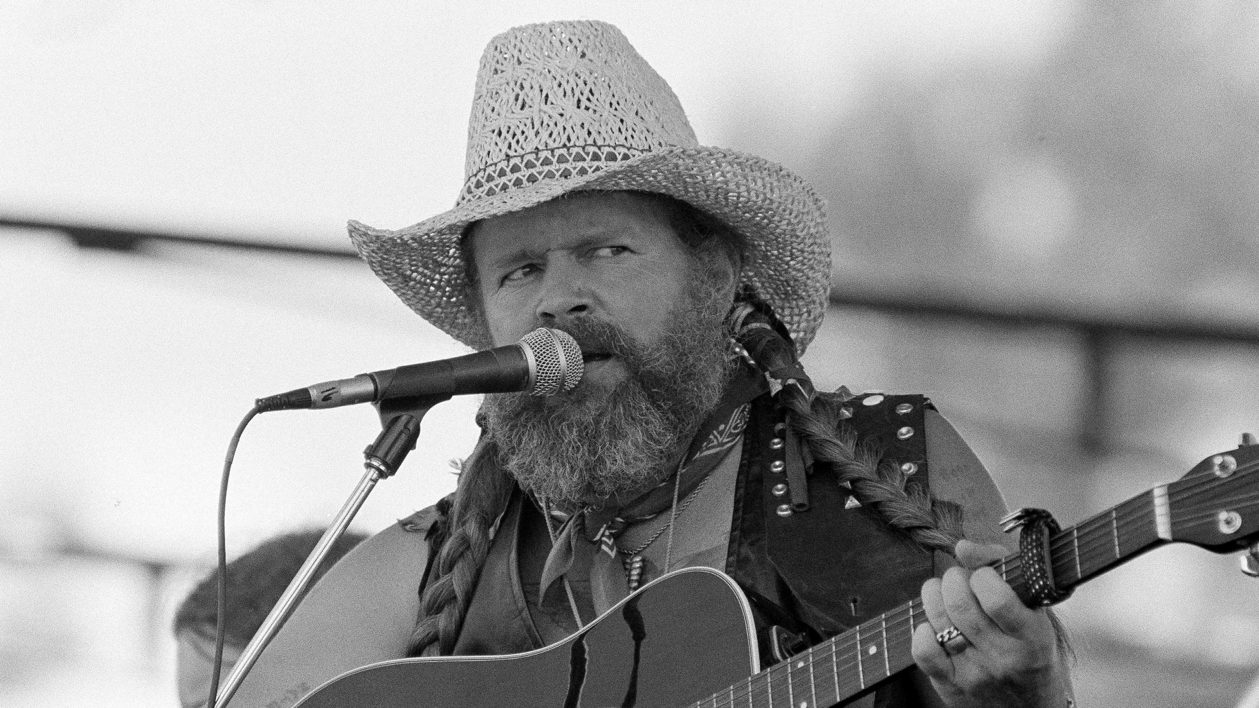 David Allan Coe, sporting Willie Nelson braids, performs at the Willie Nelson July 4th Picnic, on July 4, 1983 at Atlanta International Raceway in Hampton, Ga. 