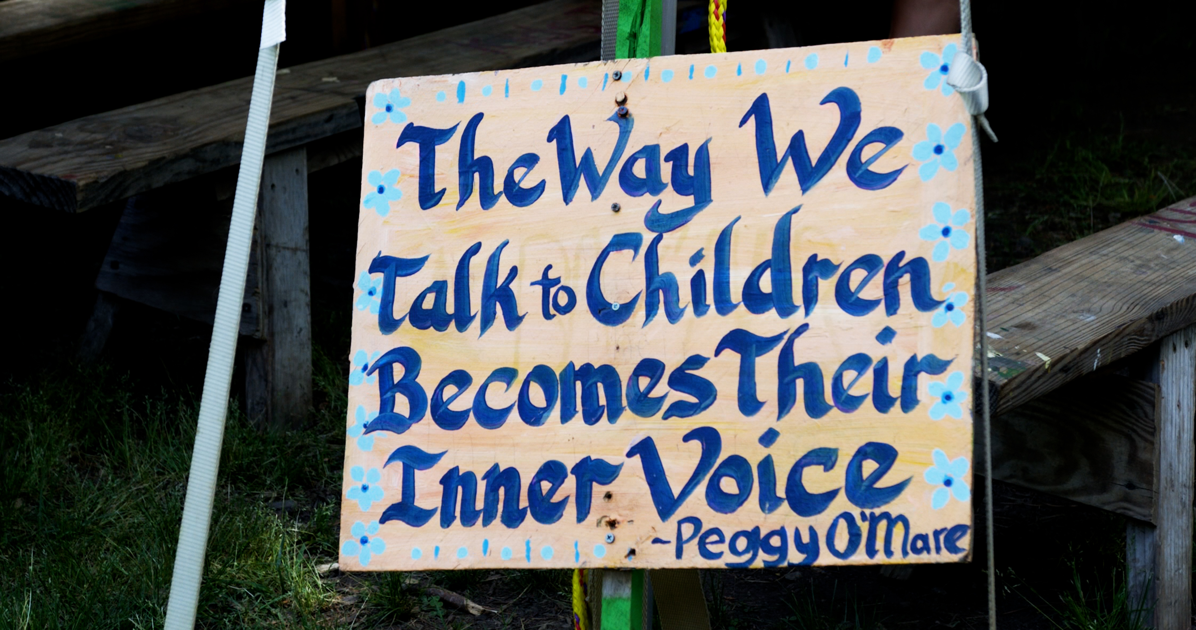 A hand-painted sign is displayed on the grounds at Shakori Hills.