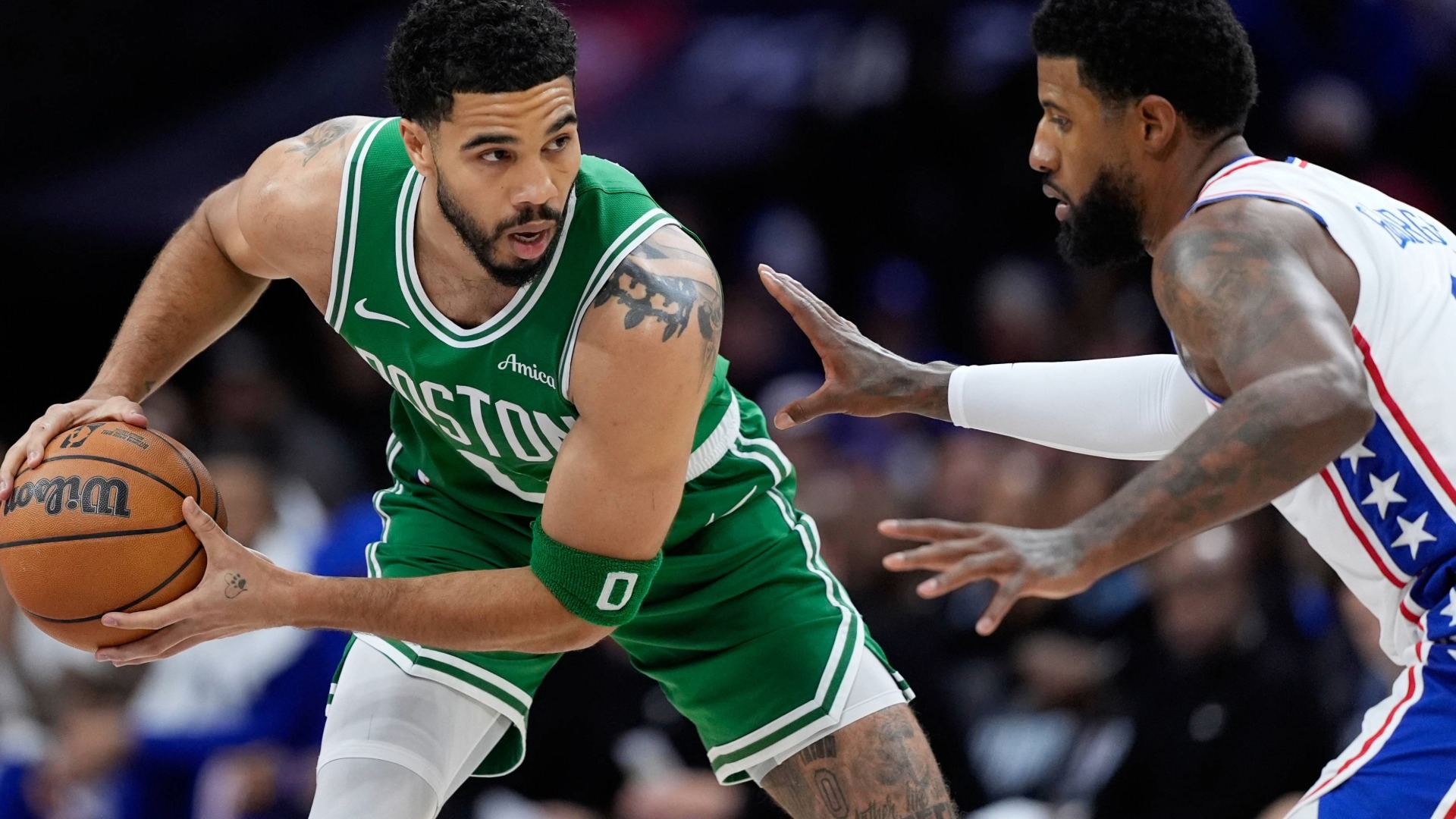 Jayson Tatum, left, tries to get past Philadelphia 76ers' Paul George during the first half of Game 6 in a first-round NBA basketball playoff series Thursday, April 30, 2026.