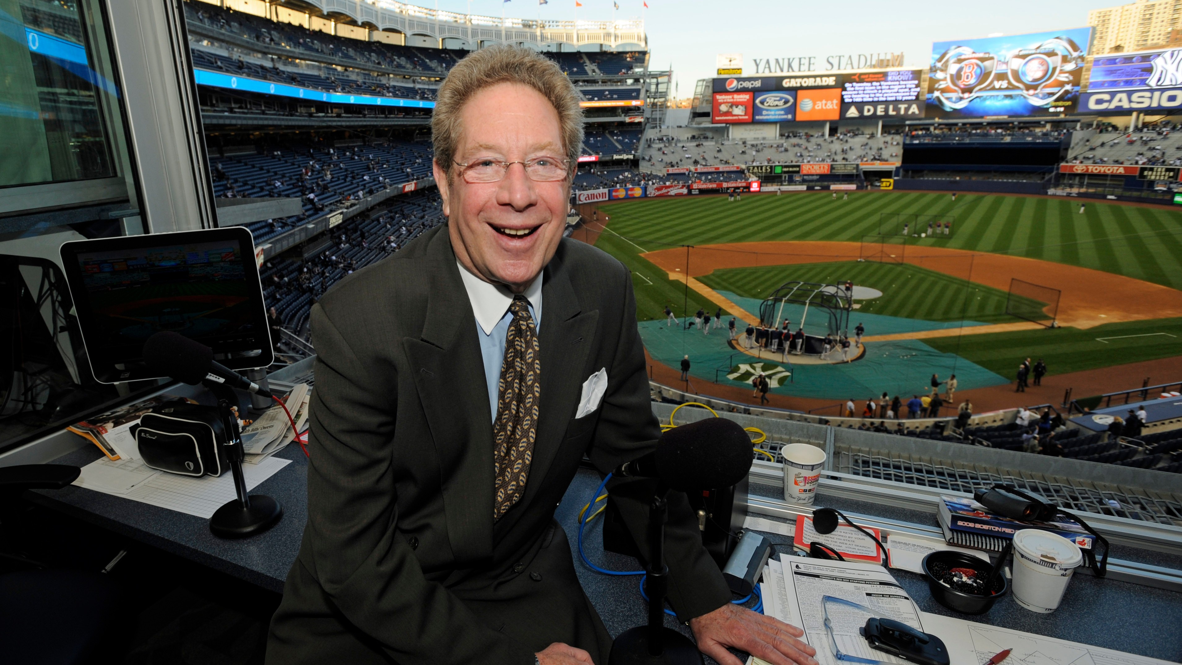 New York Yankees broadcaster John Sterling sitting in his booth before a baseball game against the Boston Red Sox at Yankee Stadium in New York