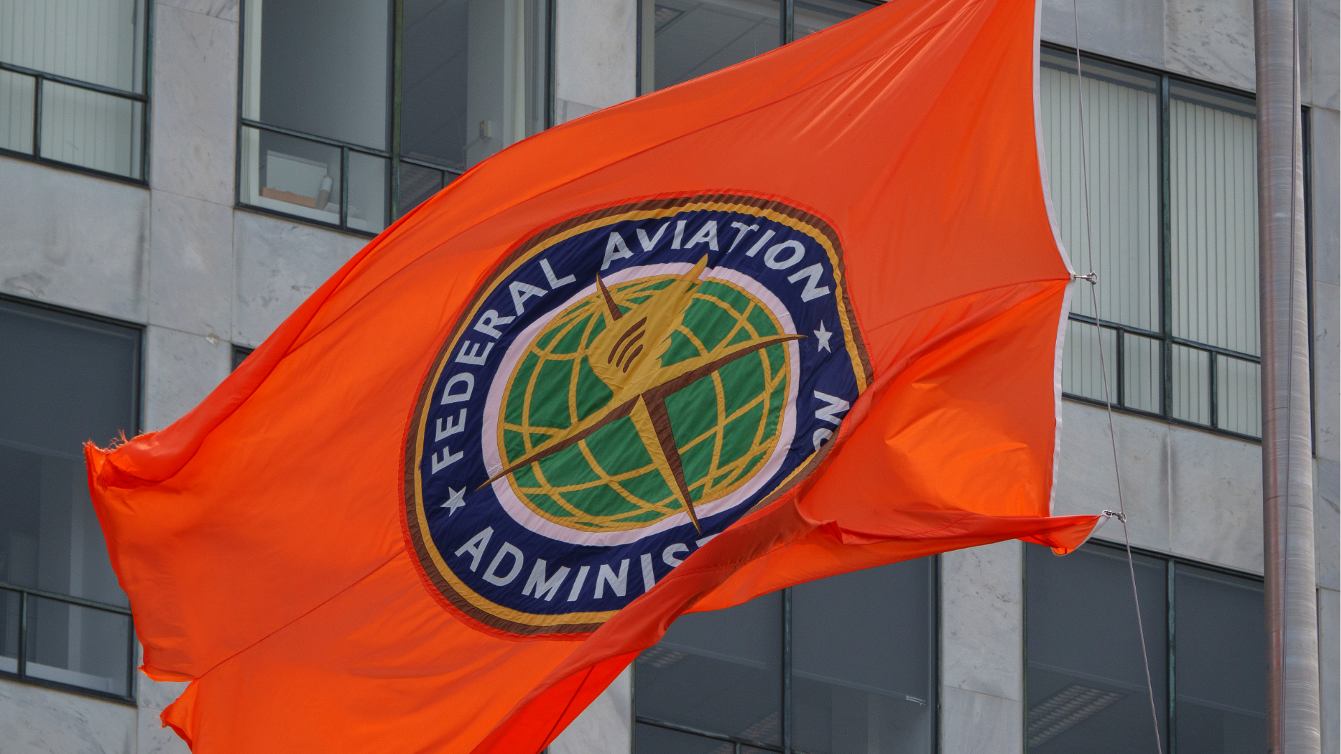 A FAA flag is displayed at the Orville Wright Federal Building which houses the Federal Aviation Administration headquarters on June, 2025 in Washington, DC.