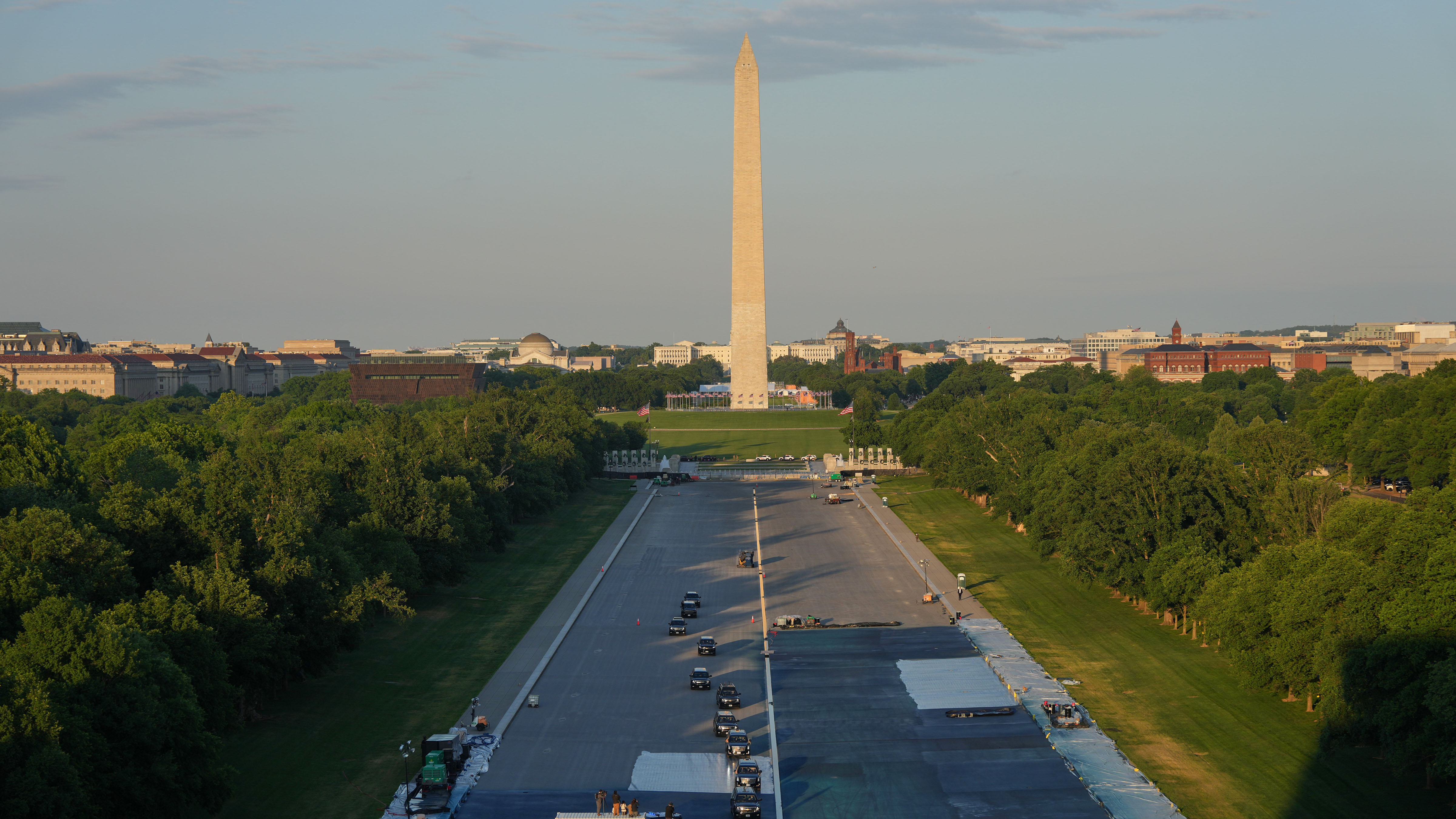 The motorcade with President Donald Trump drives in the Lincoln Memorial Reflecting Pool during a visit to see the new blue protective coating being applied as part of a renovation project, Thursday, May 7, 2026, in Washington.