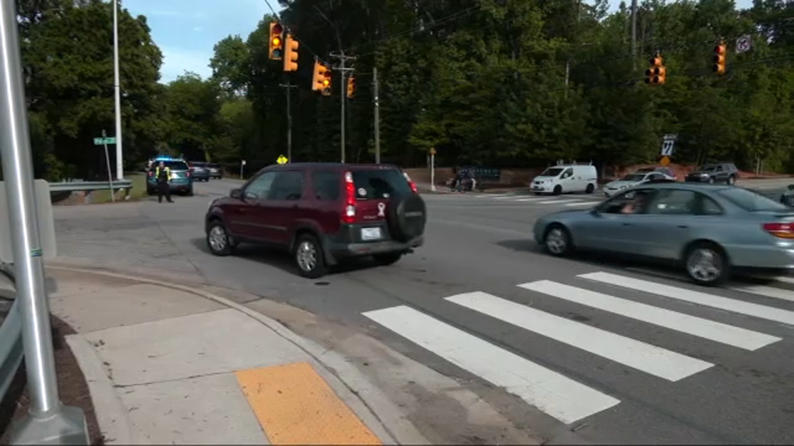 Woman charged after dragging off-duty RPD officer directing traffic