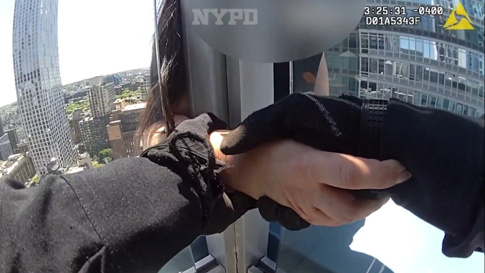 NYPD officers save woman sitting on ledge of high-rise building in ...
