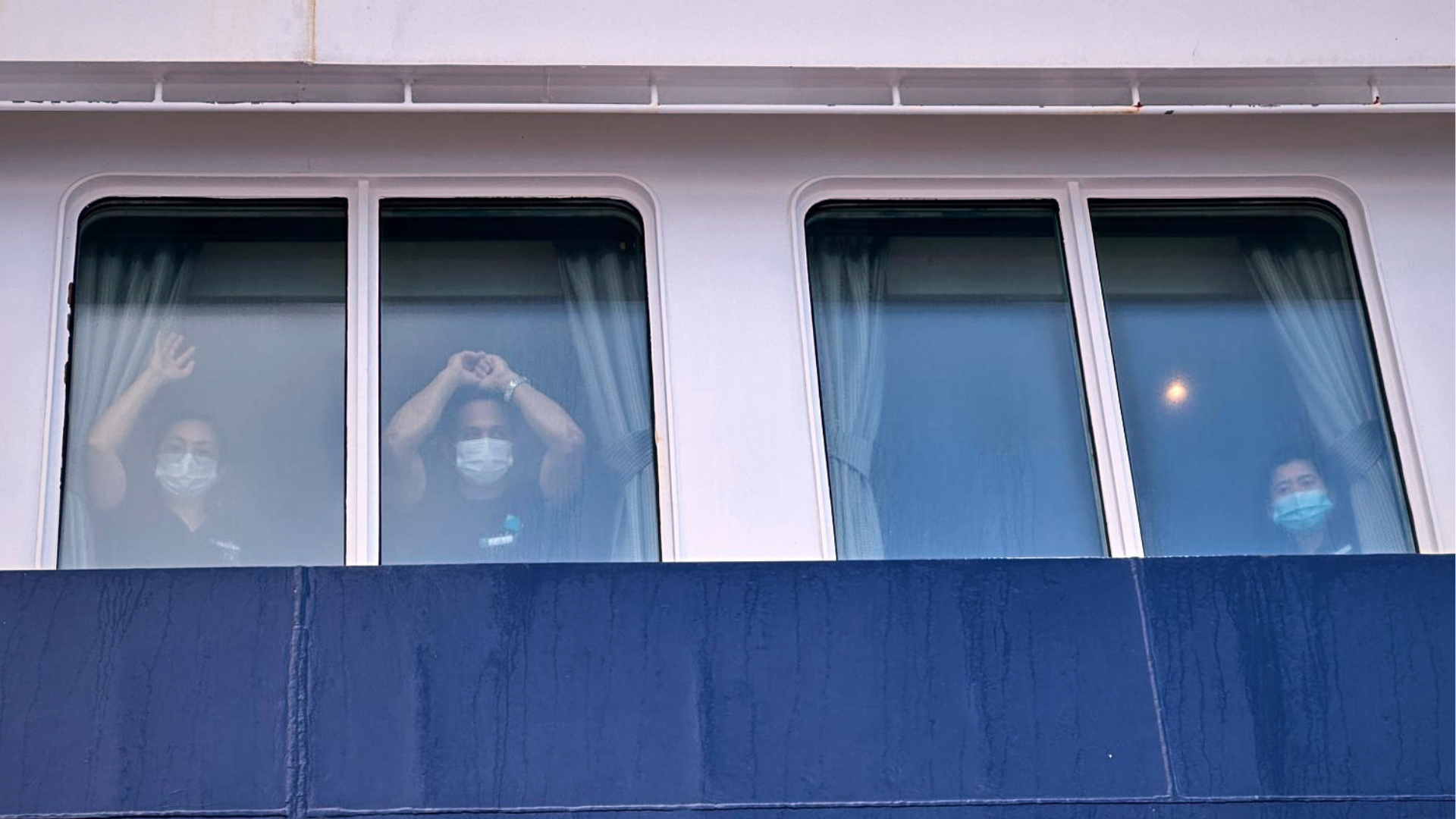 Passengers watch as others are disembarked from the hantavirus-stricken cruise ship MV Hondius at the port of Granadilla in Tenerife, Canary Islands, Spain, Sunday, May 10, 2026.