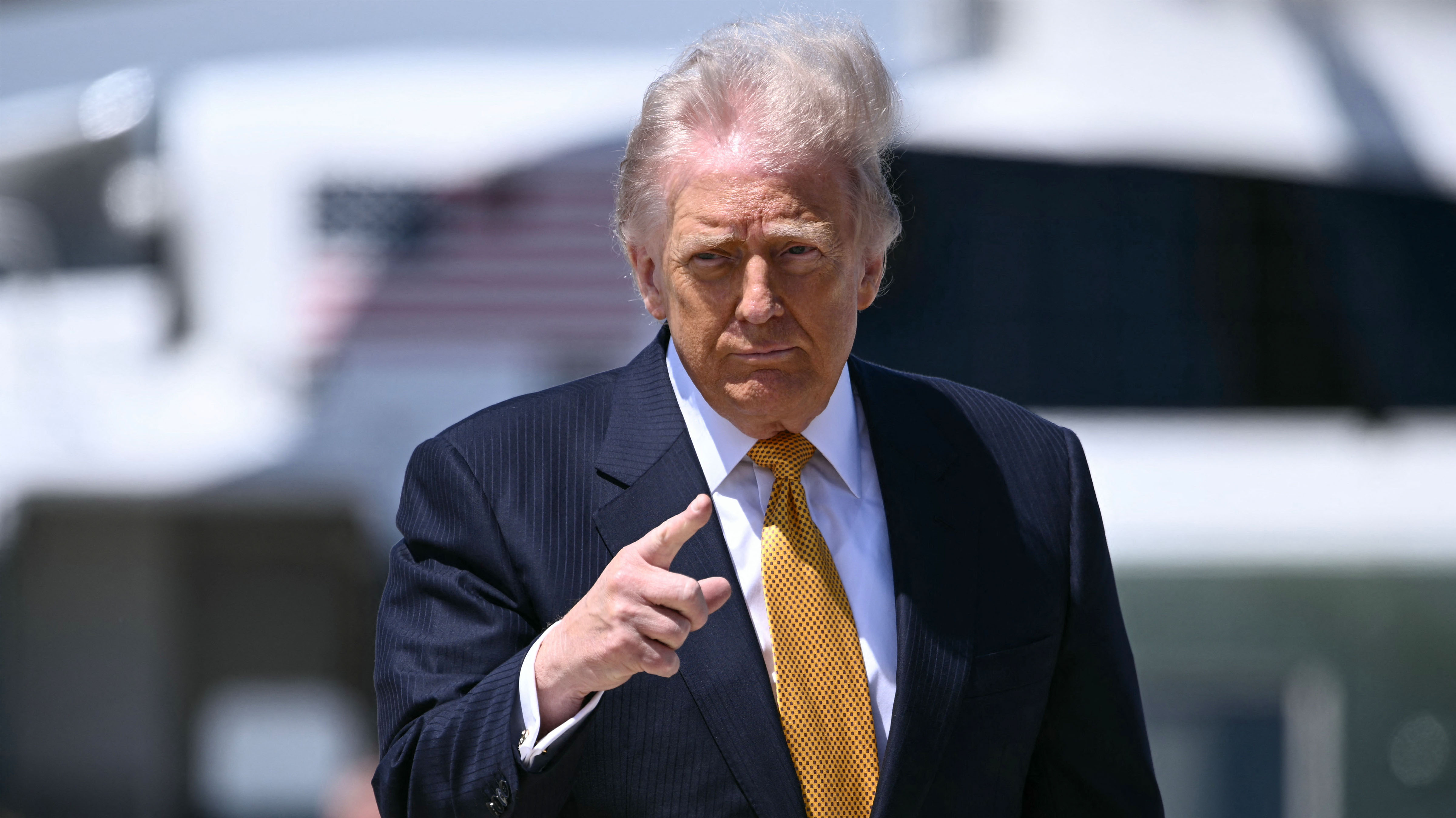 US President Donald Trump gestures prior boarding Air Force One at Joint Base Andrews, Maryland, on May 12, 2026 as he departs for a 3-day state visit to China.