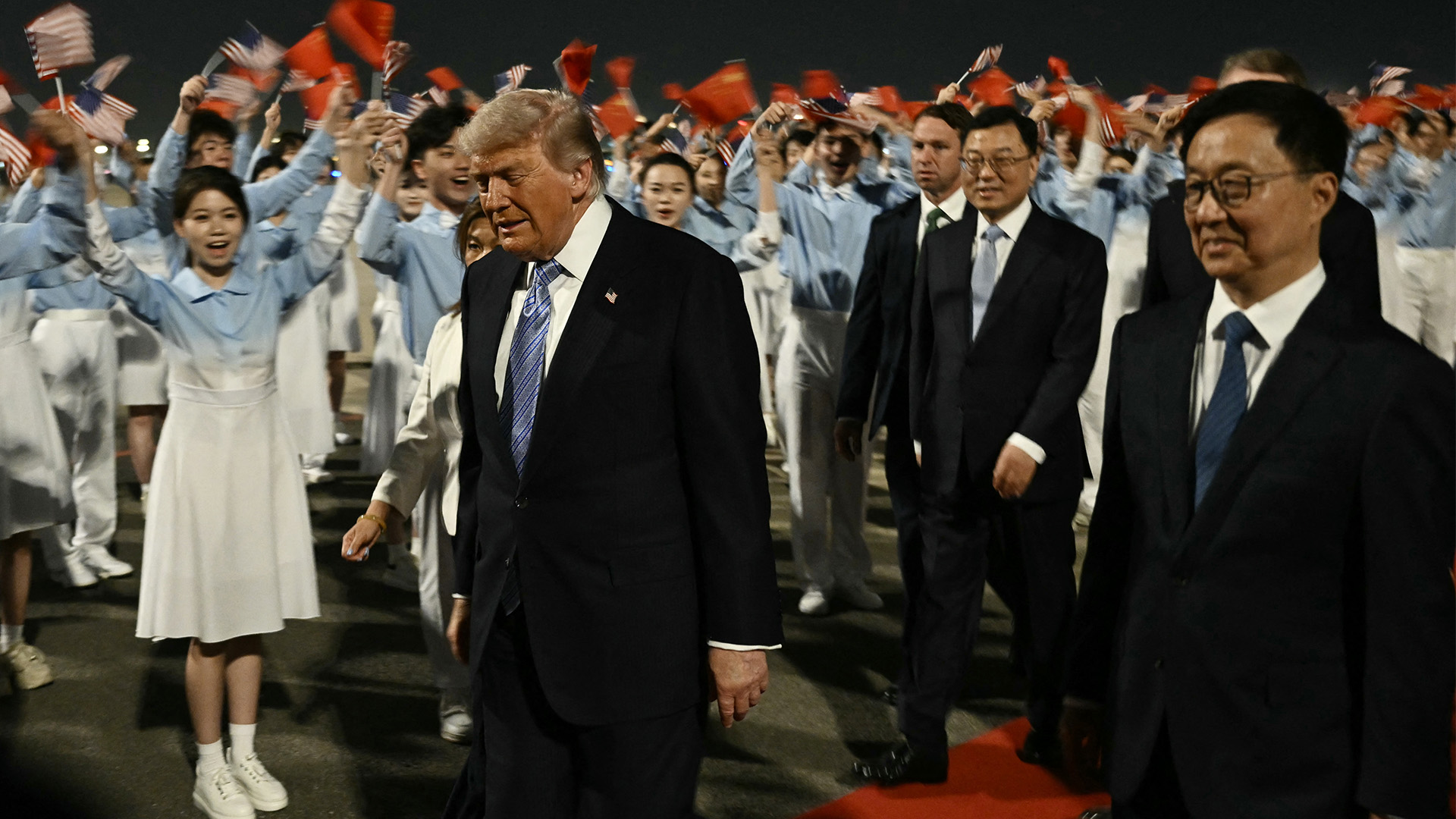 President Donald Trump is escorted by China's Vice President Han Zheng upon his arrival at Beijing Capital Airport in Beijing on May 13, 2026. 