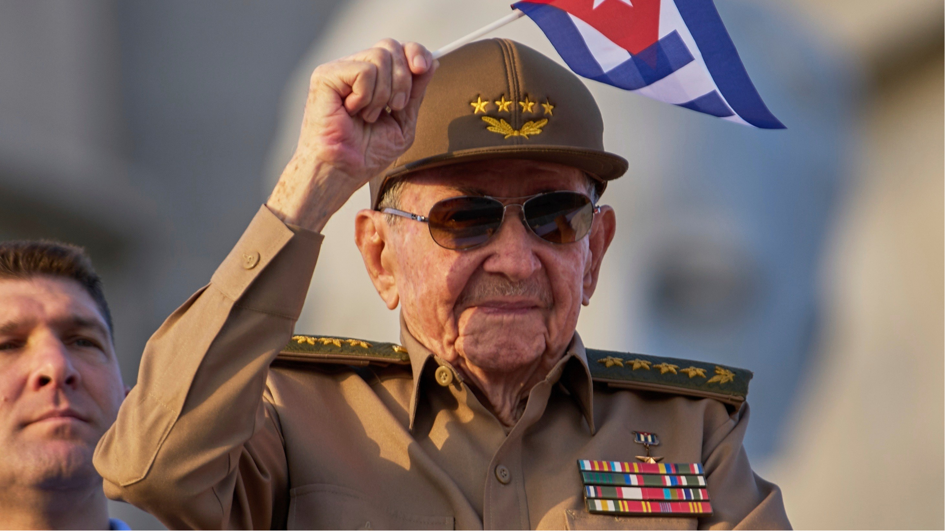 FILE - Raul Castro waves a Cuban national flag during a May Day parade at Revolution Square in Havana on May 1, 2025.