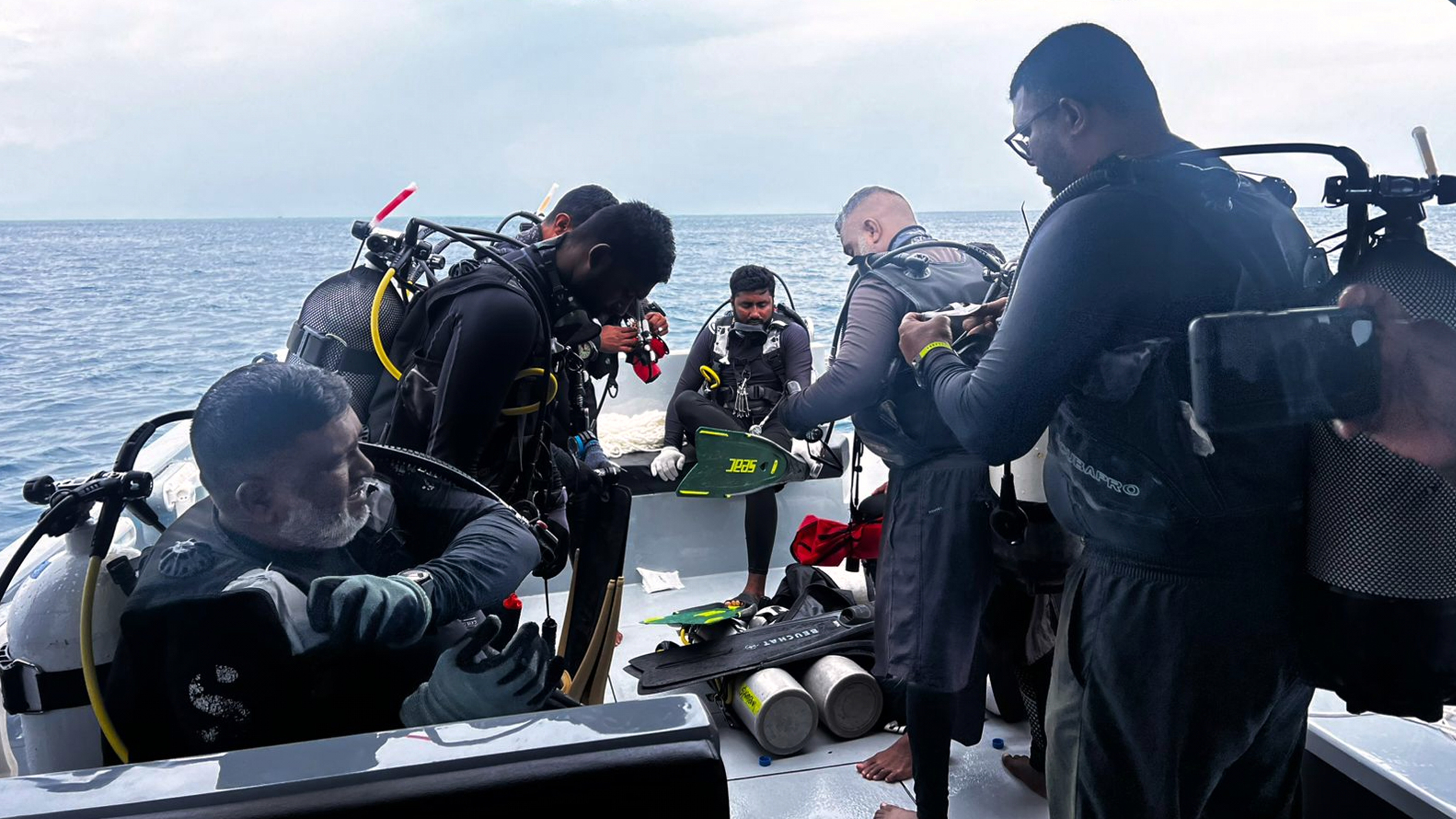 This image released by the Maldives President's Media Division, shows divers preparing to search for the four missing Italian divers near Alimathaa Island, Vaavu Atoll, Maldives, Saturday, May 15, 2026. 