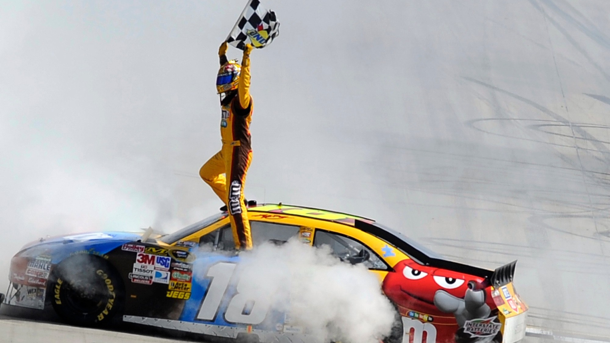 FILE - Kyle Busch celebrates his win in the NASCAR Sprint Cup Series' Autism Speaks 400 auto race, Sunday, May 16, 2010, in Dover, Del. (AP Photo/Nick Wass, File)