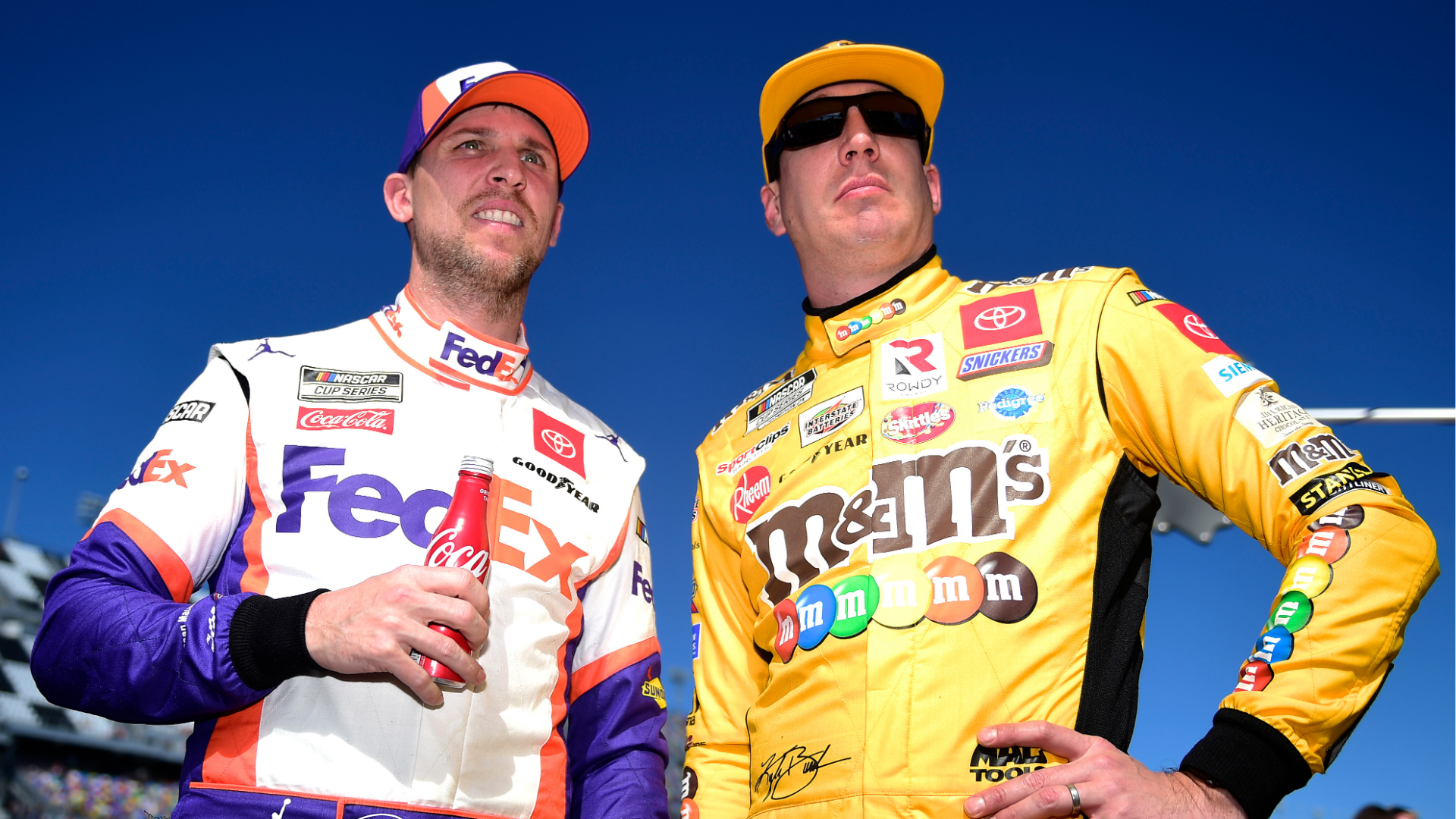 Denny Hamlin, left, Kyle Busch, right, stand on the grid during qualifying for the NASCAR Cup Series 62nd Annual Daytona 500 at Daytona International Speedway on February 09, 2020 in Daytona Beach, Florida