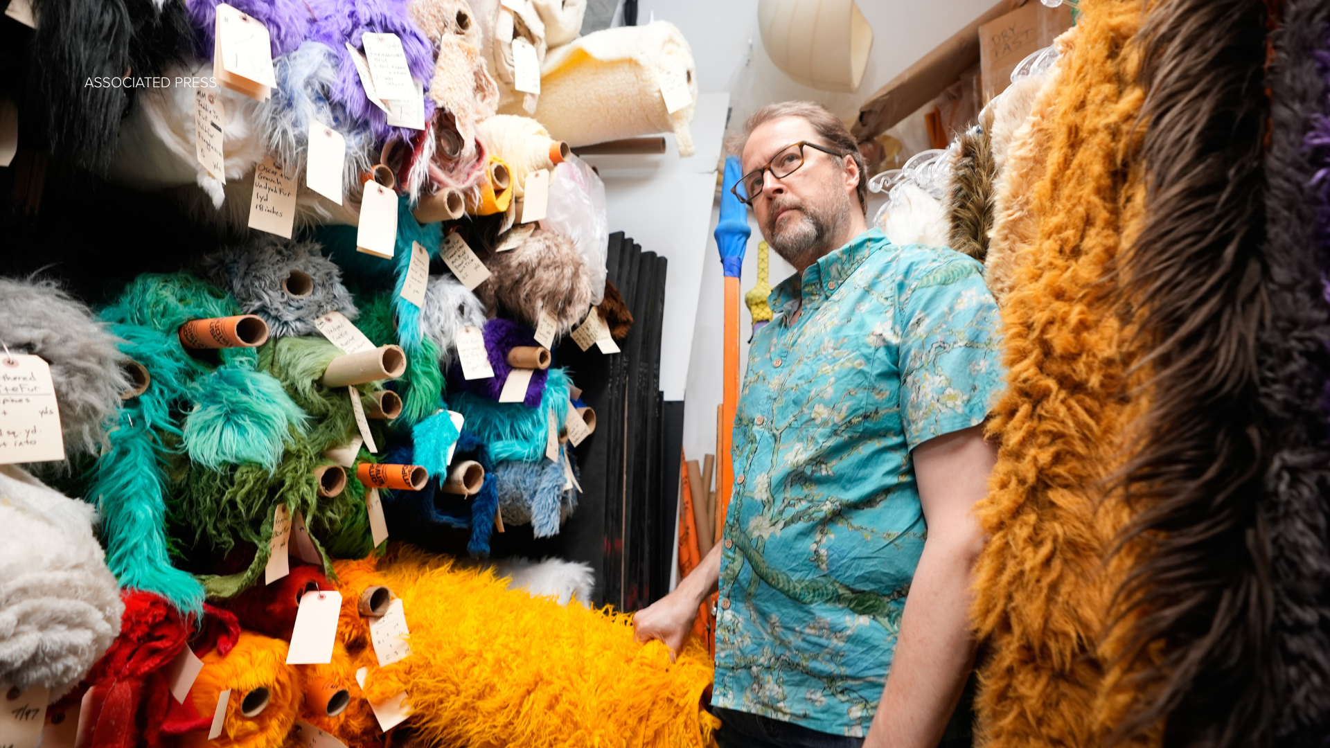 Jason Weber, creative director of Jim Henson's Creature Shop, shows different fabrics at the shop in New York, Wednesday, May 13, 2026. (AP Photo/Seth Wenig)