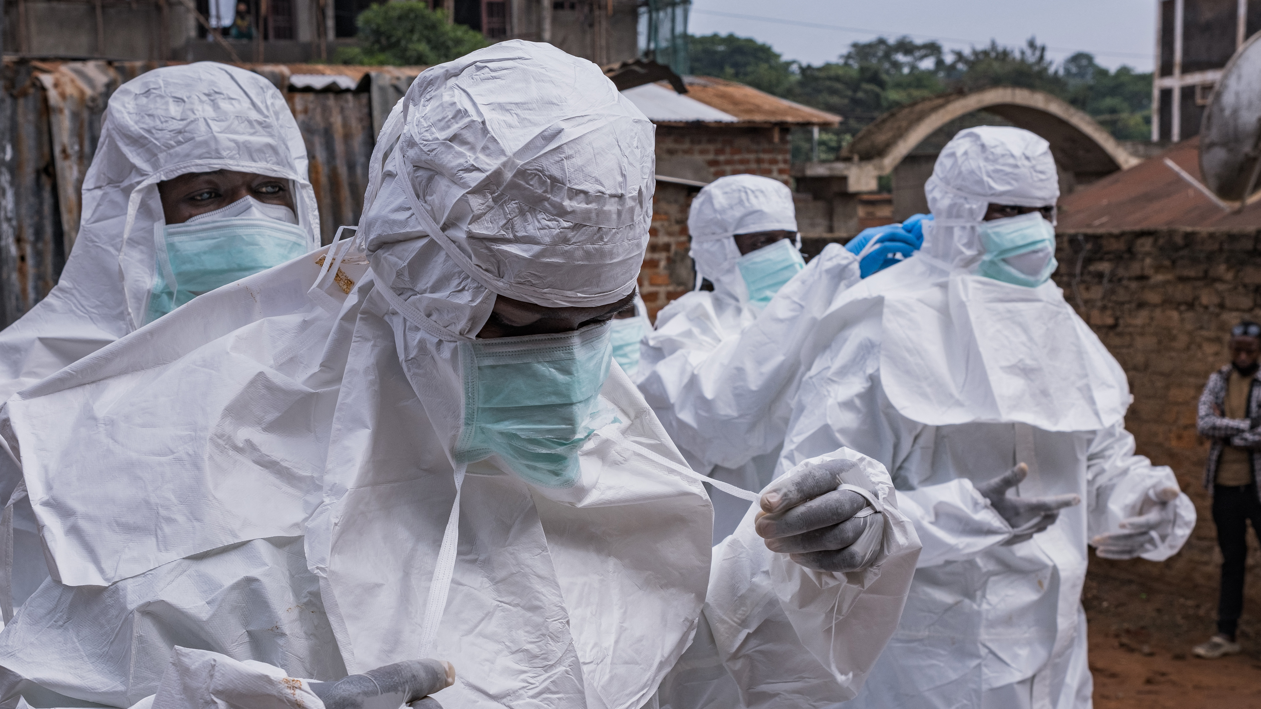 Workers from the Uganda Red Cross Society don protective suits as they prepare to evacuate the body of a suspected Ebola victim in Kampala on May 26, 2026.