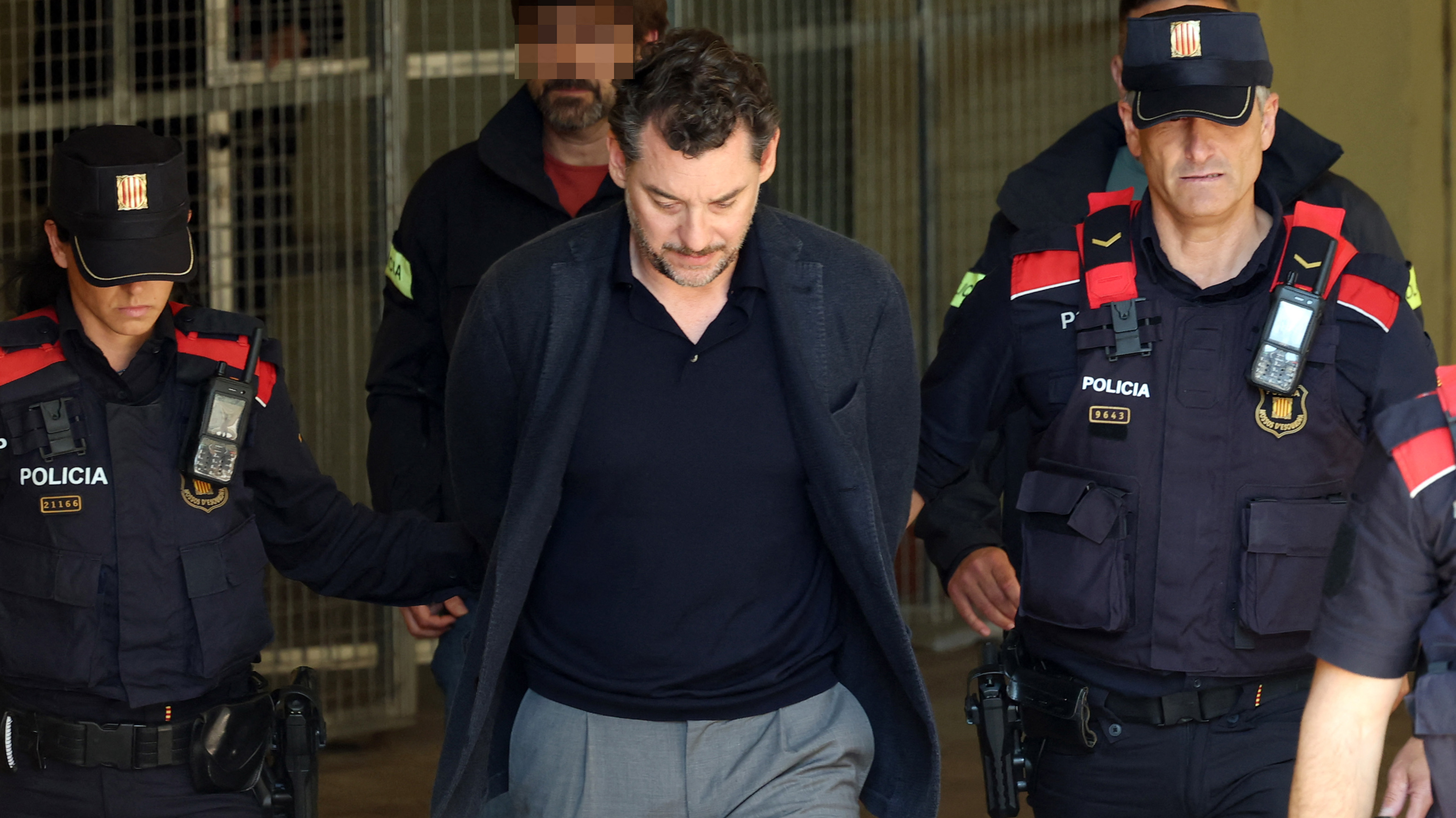 Catalan regional police officers escort Jonathan Andic, the son of Isak Andic, founder of Spanish fashion brand Mango, as he arrives at a court in Martorell, near Barcelona, following his arrest on May 19, 2026.