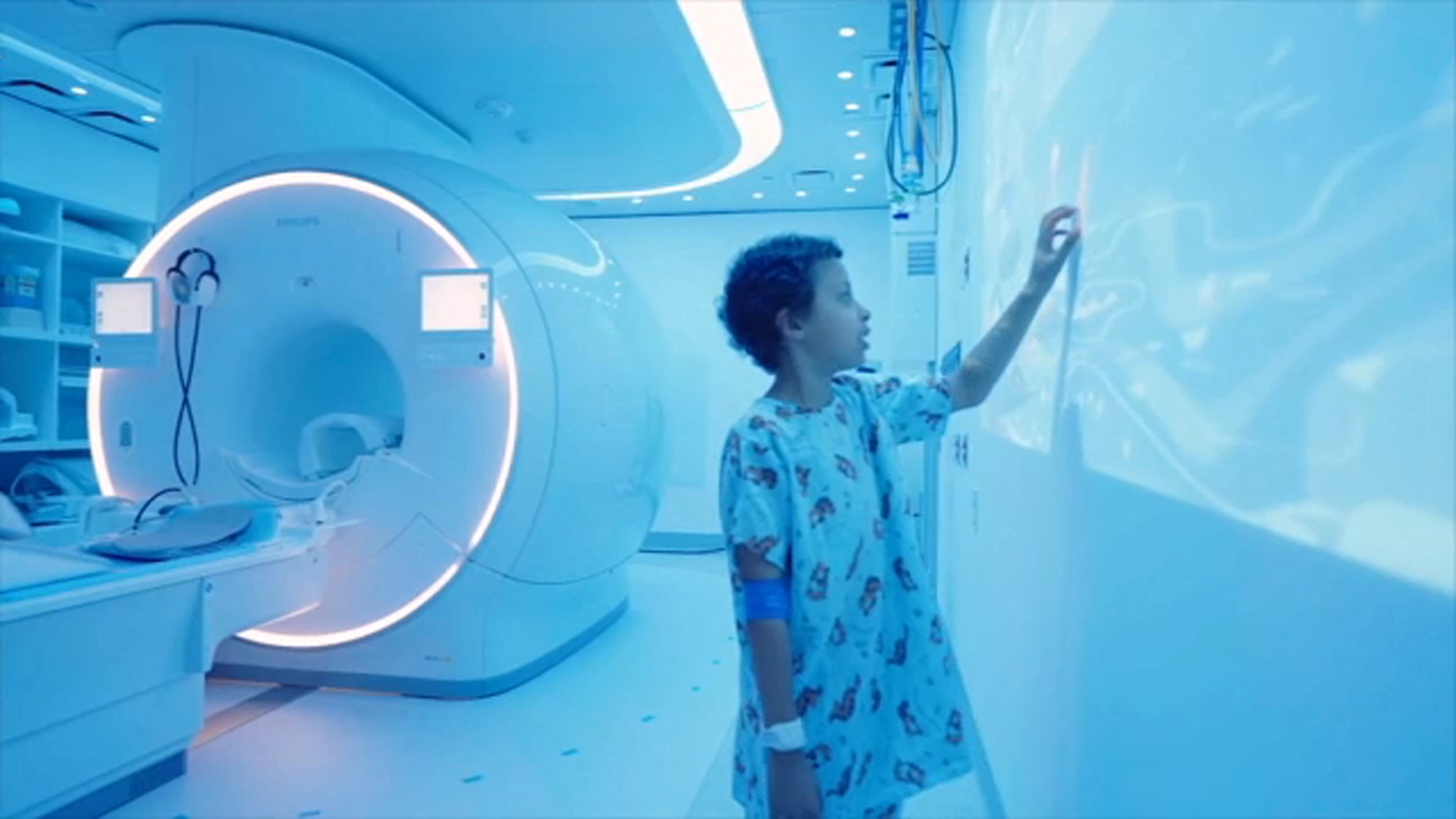 Jordan Mosley, 8, interacts with the Disney images focused on storytelling to help with MRI scans.