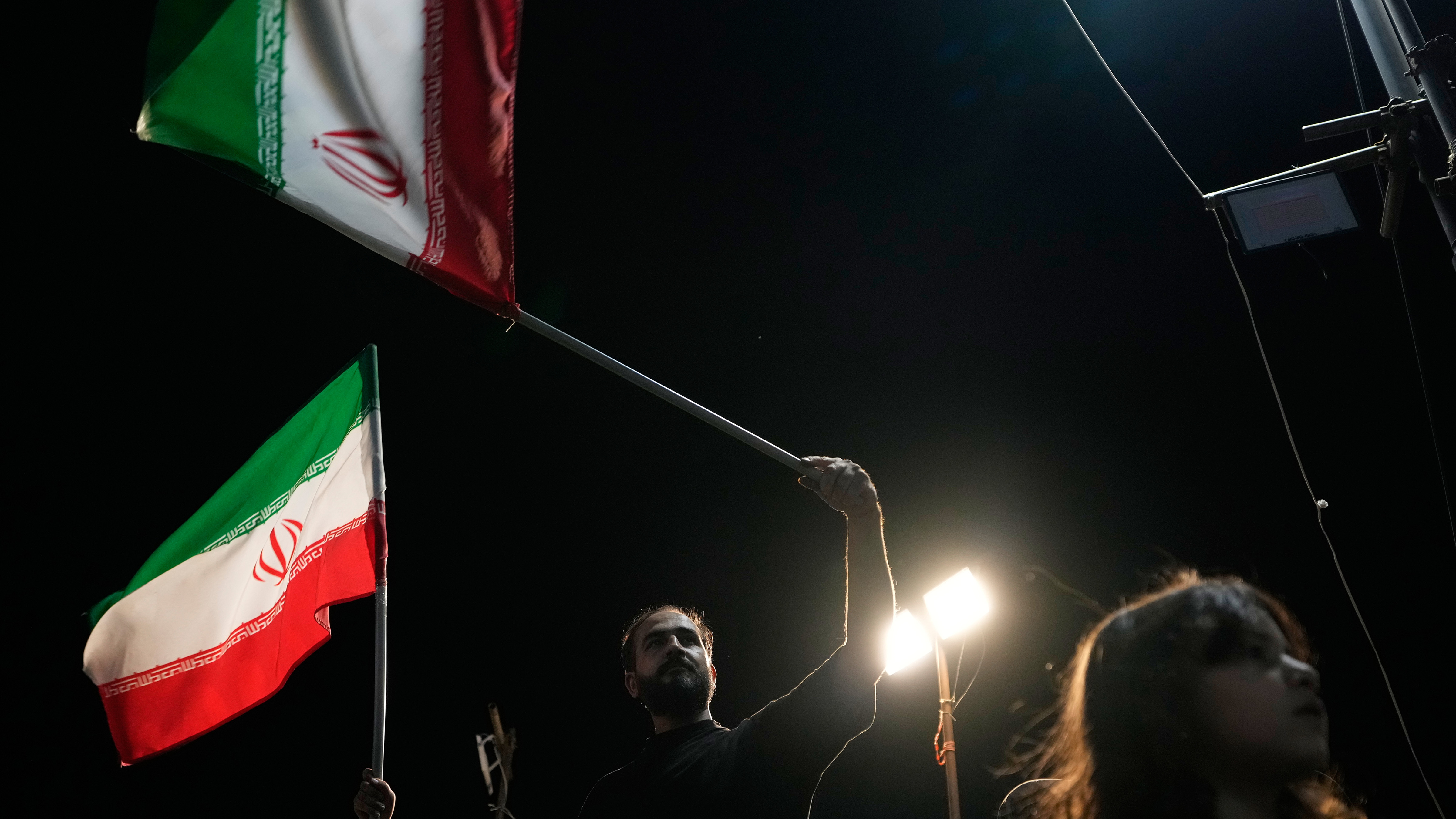 Demonstrators wave Iranian flags during a pro-government gathering at Islamic Revolution Square in Tehran, Iran, Saturday, May 30, 2026.