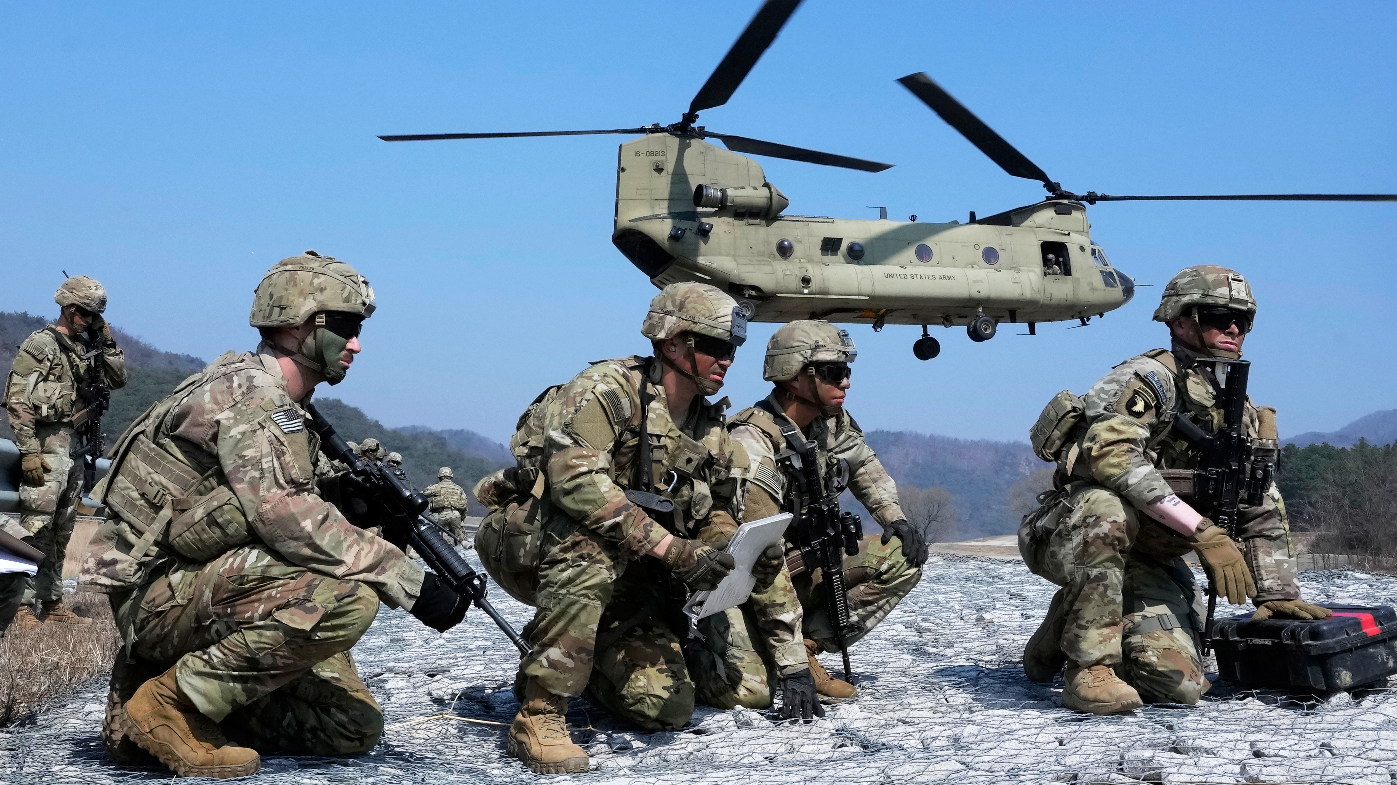 U.S. Army soldiers wait to board their CH-47 Chinook helicopter during a joint military drill between South Korea and the United States at Rodriguez Live Fire Complex in Pocheon, South Korea, Sunday, March 19, 2023.
