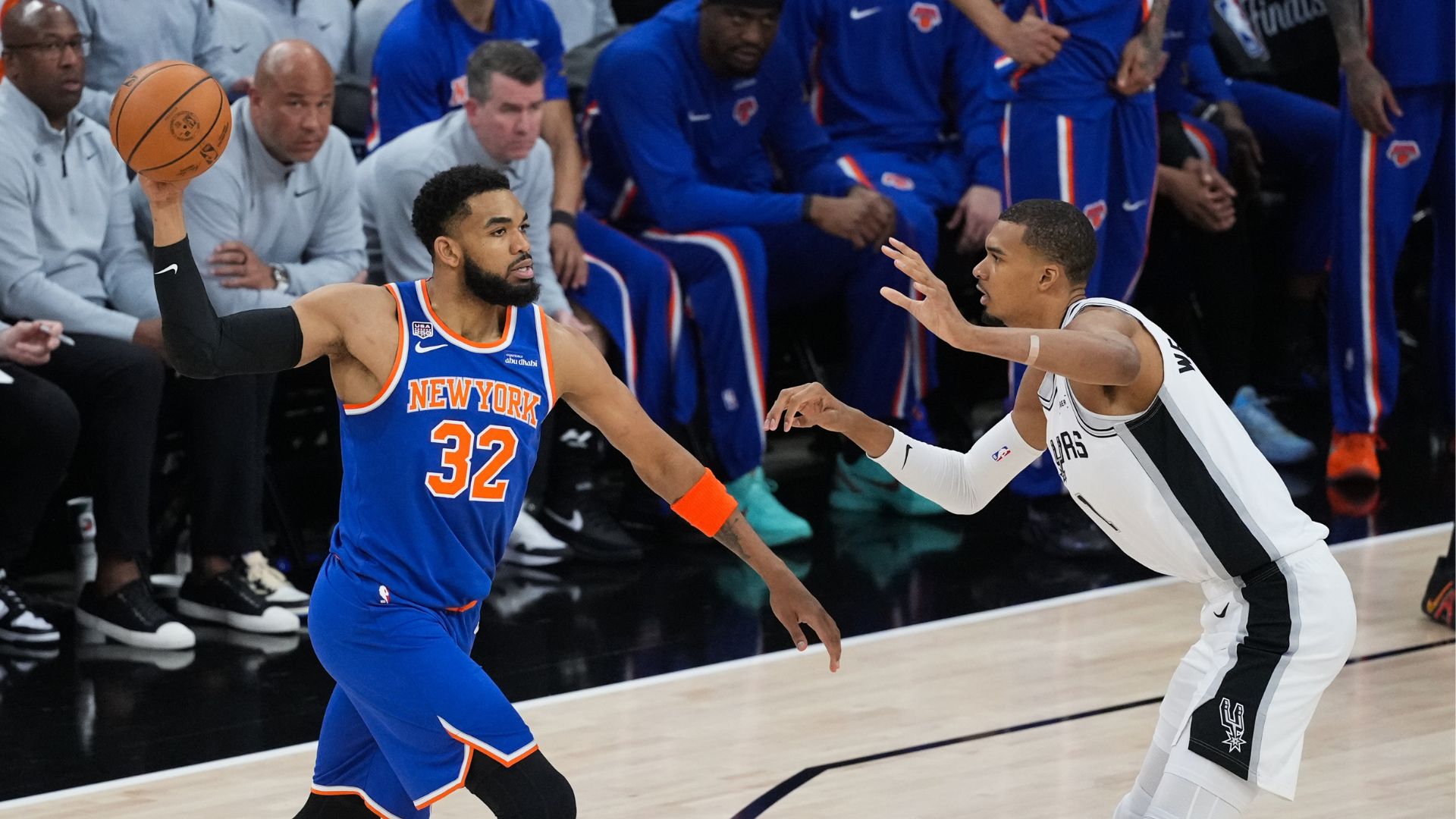 New York Knicks center Karl-Anthony Towns (32) looks to pass as San Antonio Spurs forward Victor Wembanyama (1) defends during the first half of Game 2. (AP Photo/Eric Gay)