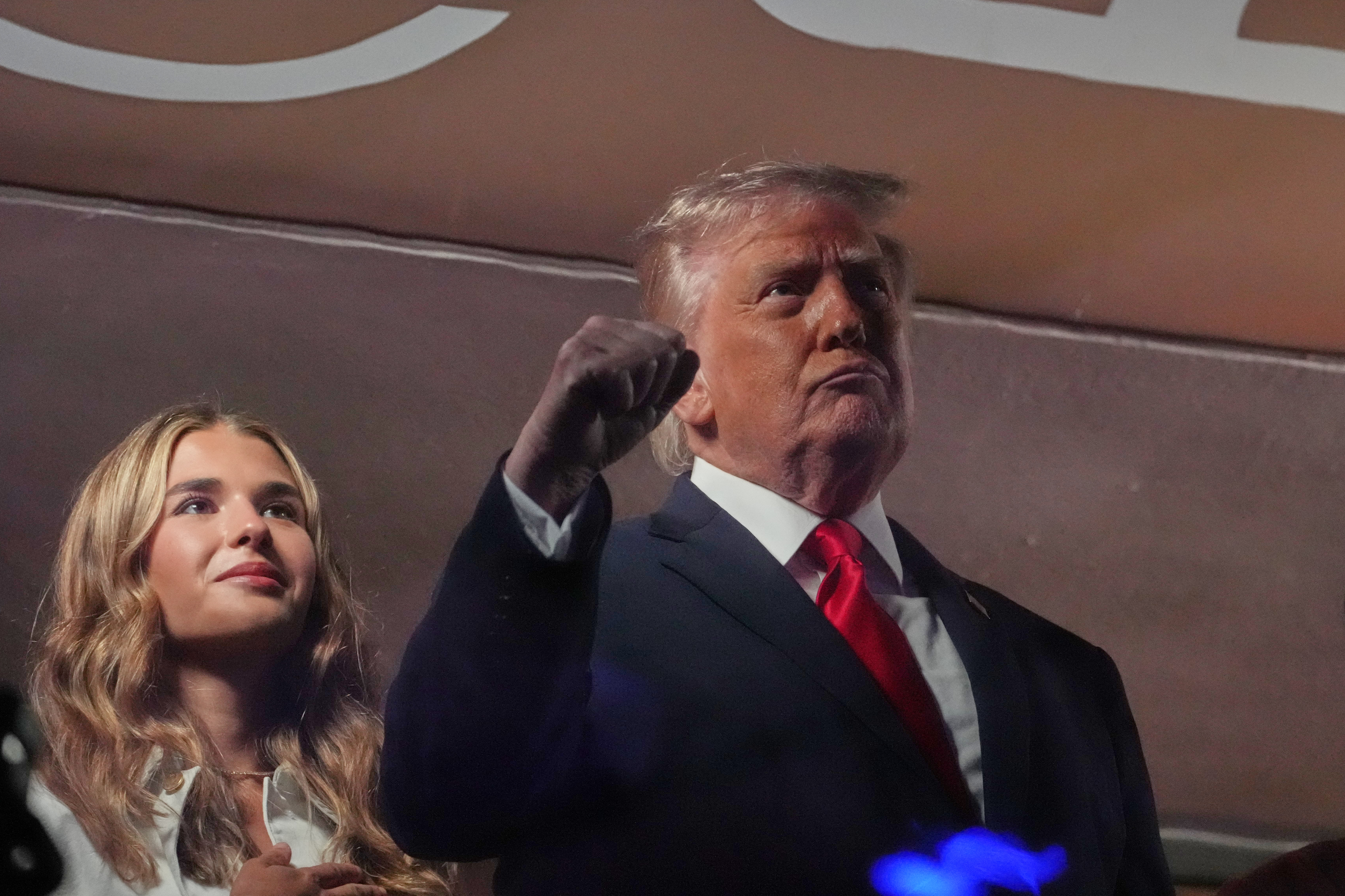 President Trump gestures during the National Anthem as he attends Game 3 of the NBA Finals at Madison Square Garden, with Kai Trump, left. (AP Photo/Mark Schiefelbein)