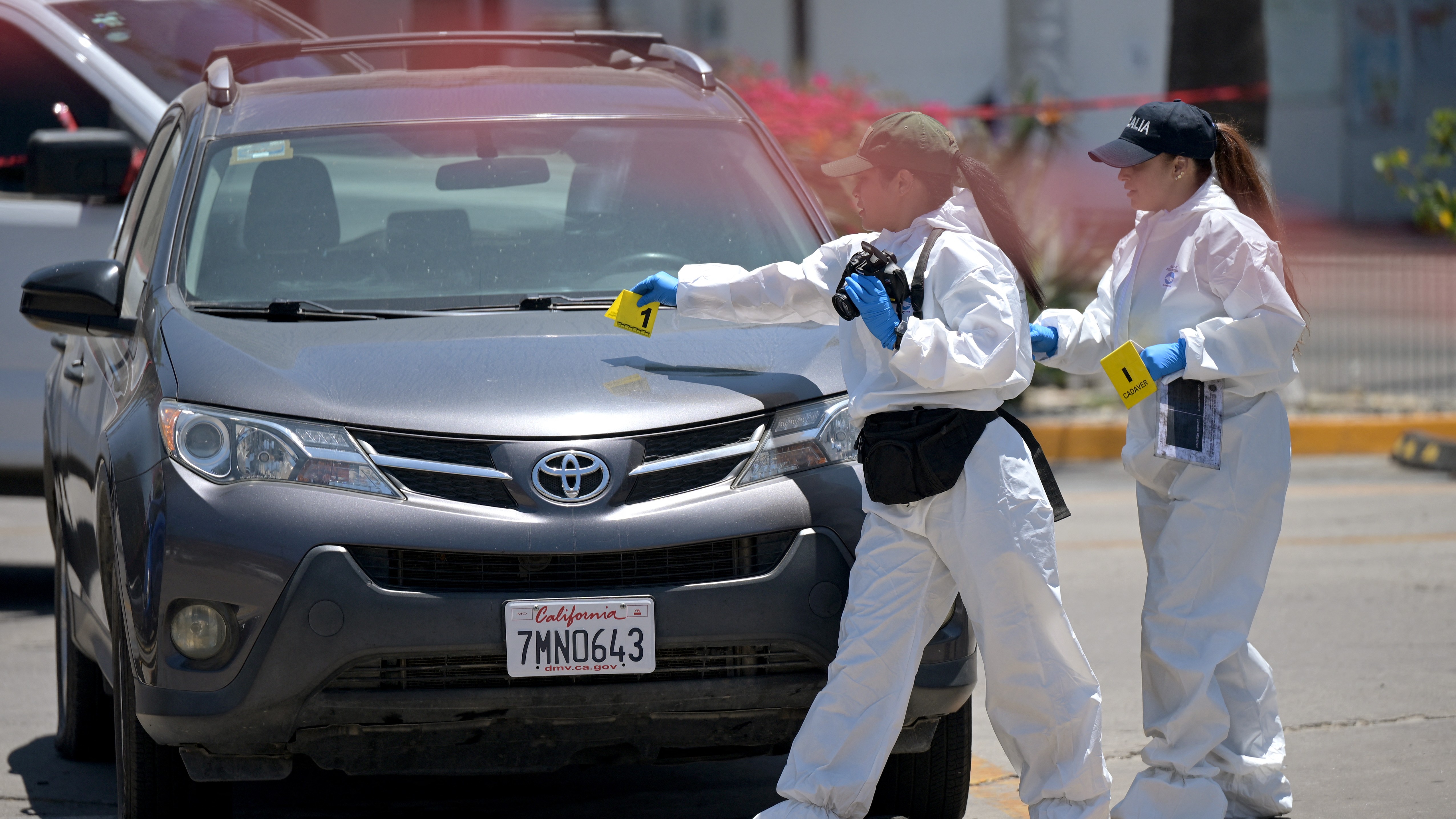 Forensic workers inspect a car where a body was allegedly found at a parking lot close to Caliente stadium, where Iran's national football team trains, in Tijuana on June 12, 2026.