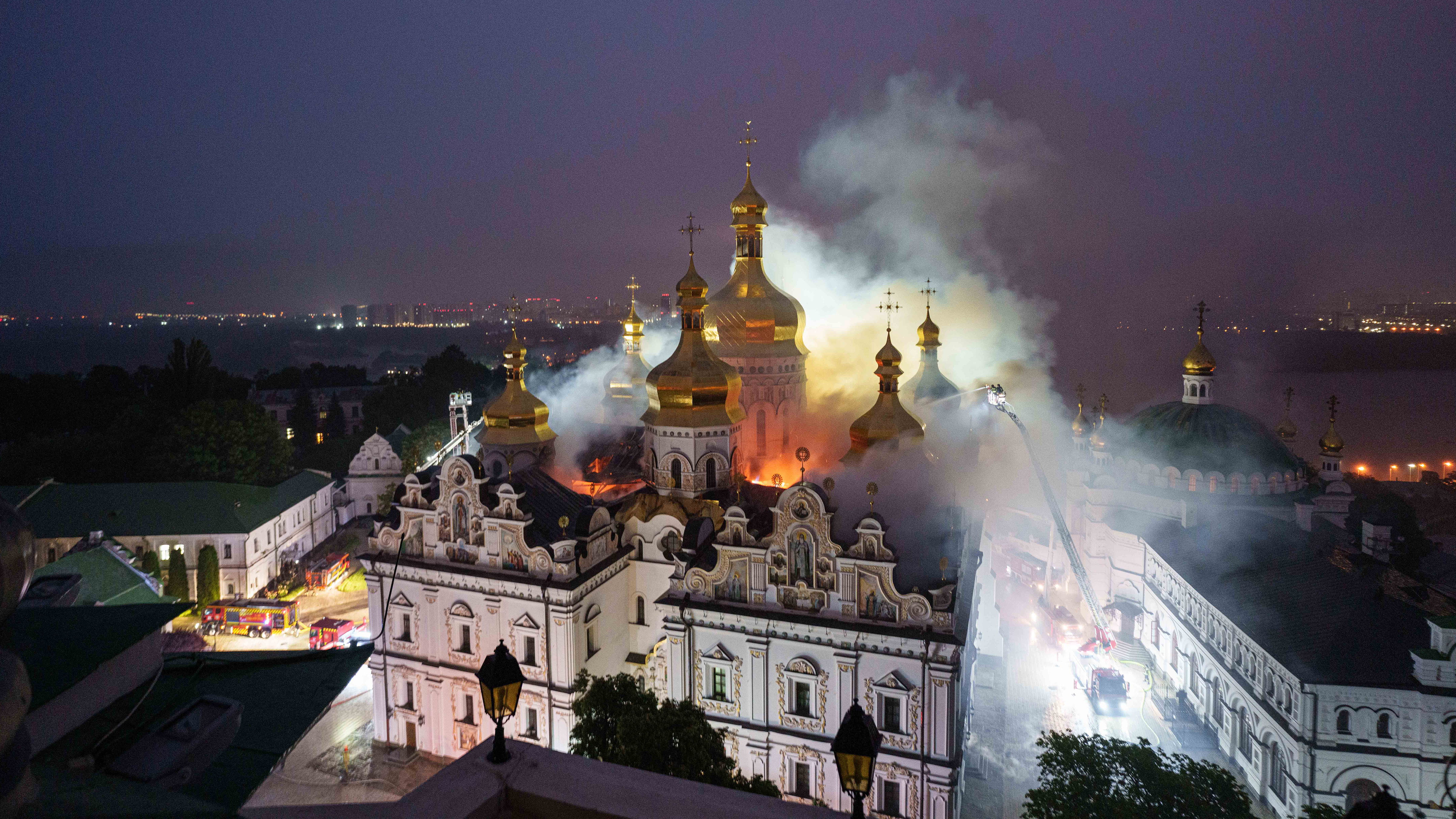 Rescue workers try to put out a fire at the Dormition Cathedral of thousand-year-old Monastery of Caves, also known as Kyiv Pechersk Lavra, following a Russian strike on Kyiv, Ukraine, Monday, June 15, 2026.