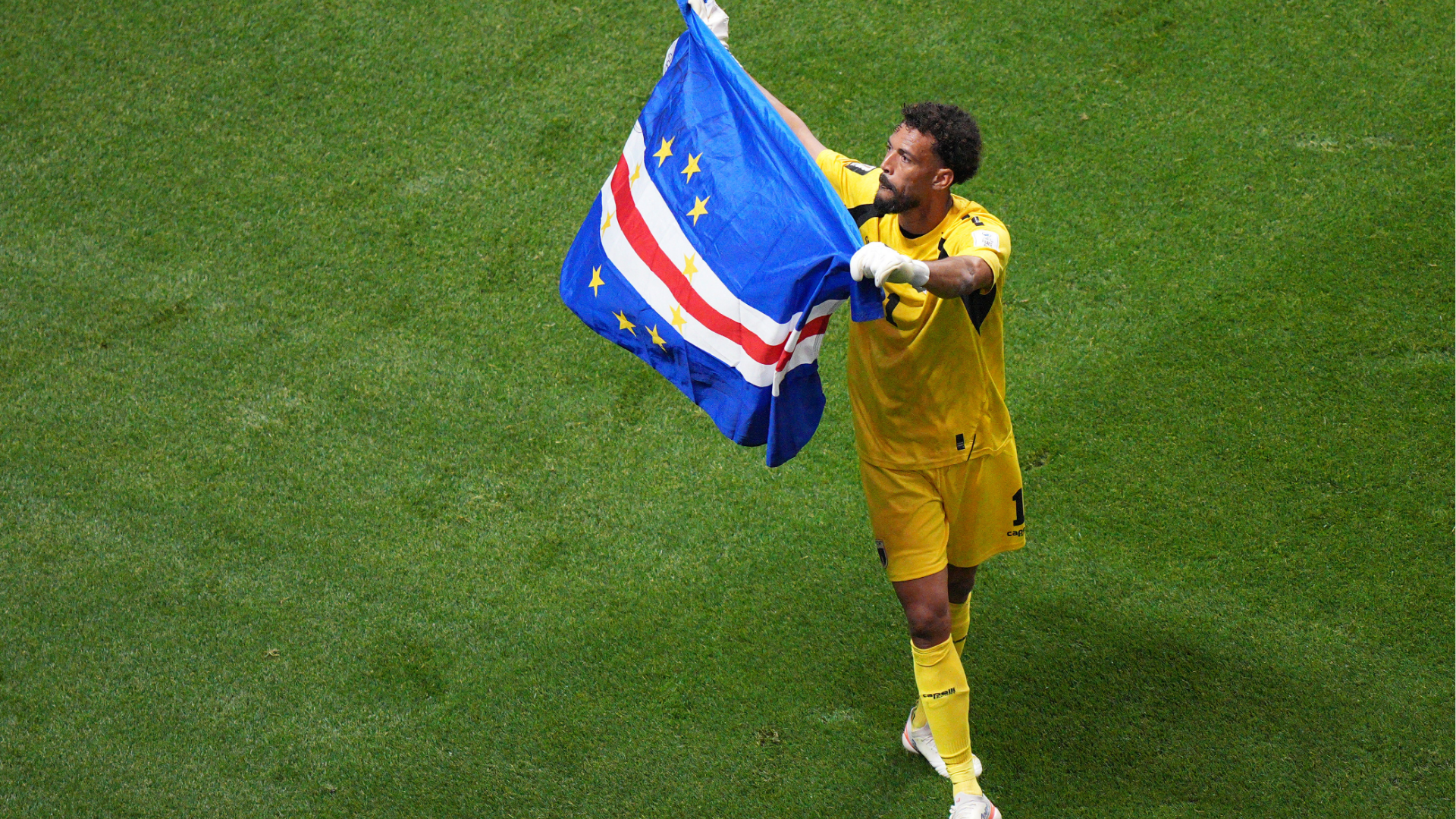 Cape Verde goalkeeper Vozinha (1) waves a flag for fans after a 0-0 draw during the World Cup Group H soccer match between Spain and Cape Verde in Atlanta, Monday, June 15, 2026.