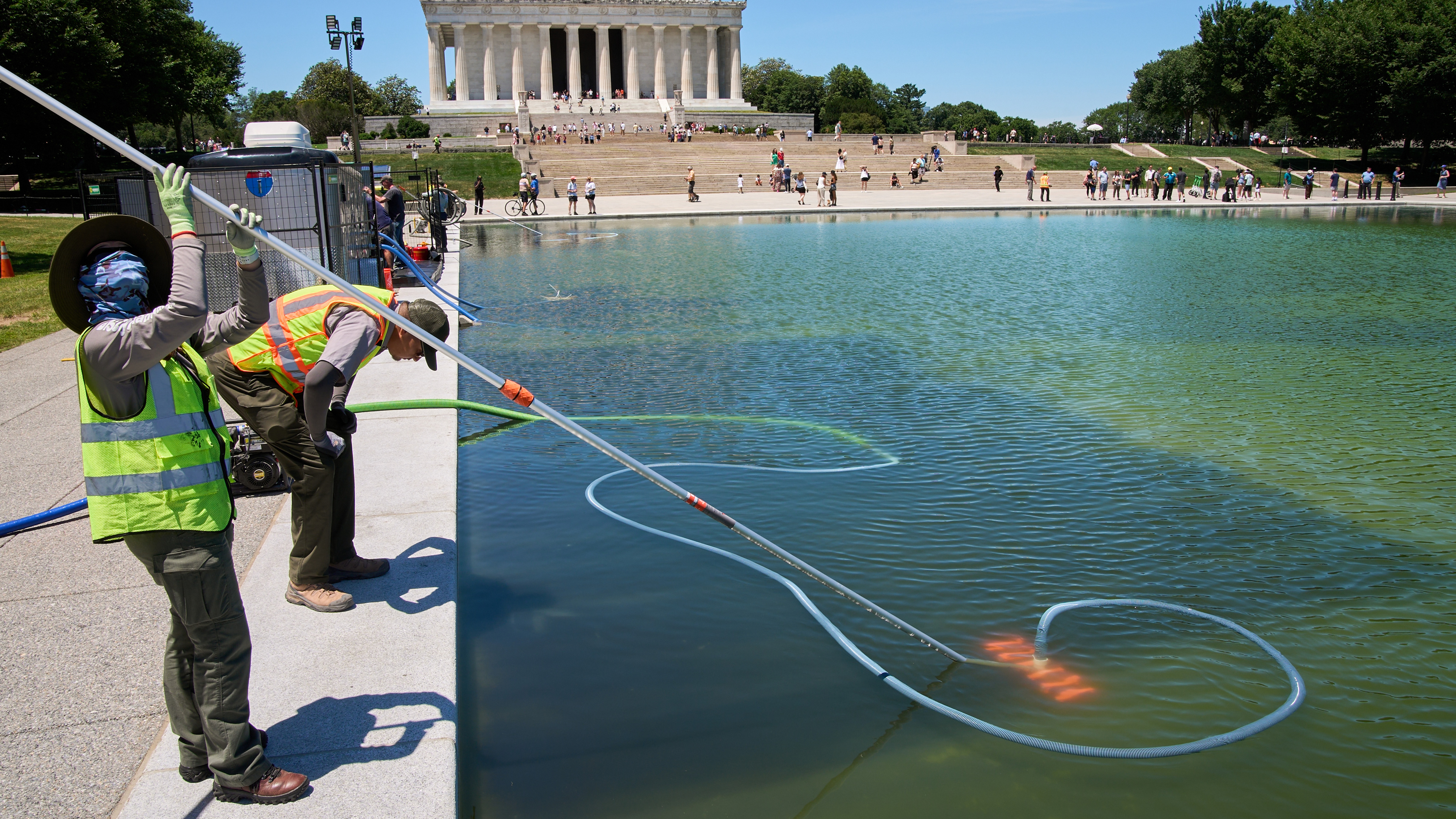 Members of the National Park Service clean algae from the Lincoln Memorial Reflecting Pool, Tuesday, June 16, 2026, in Washington.