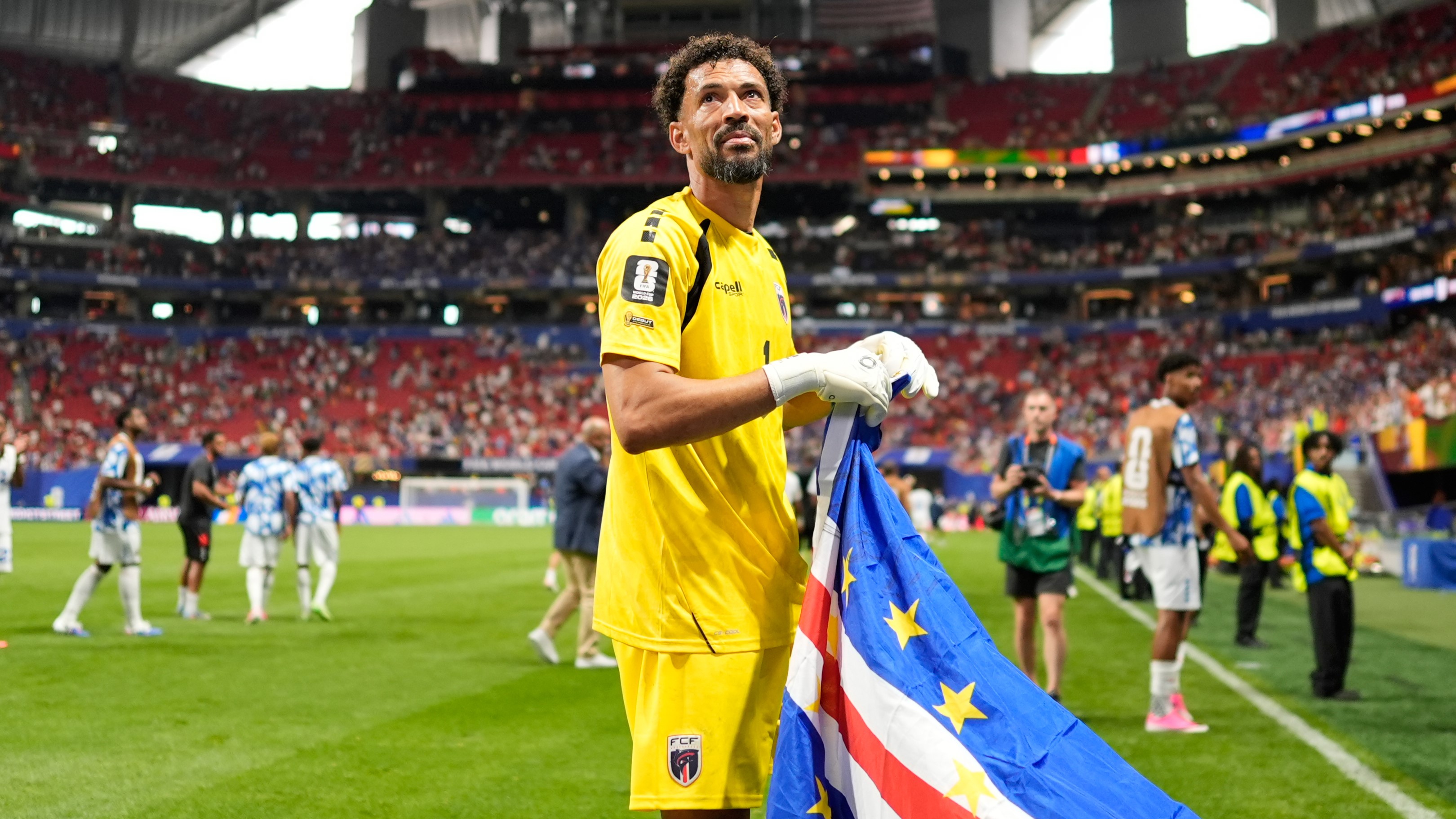 Cape Verde goalkeeper Vozinha celebrates as holds the flag of his country after the World Cup Group H soccer match between Spain and Cape Verde in Atlanta, Monday, June 15, 2026.