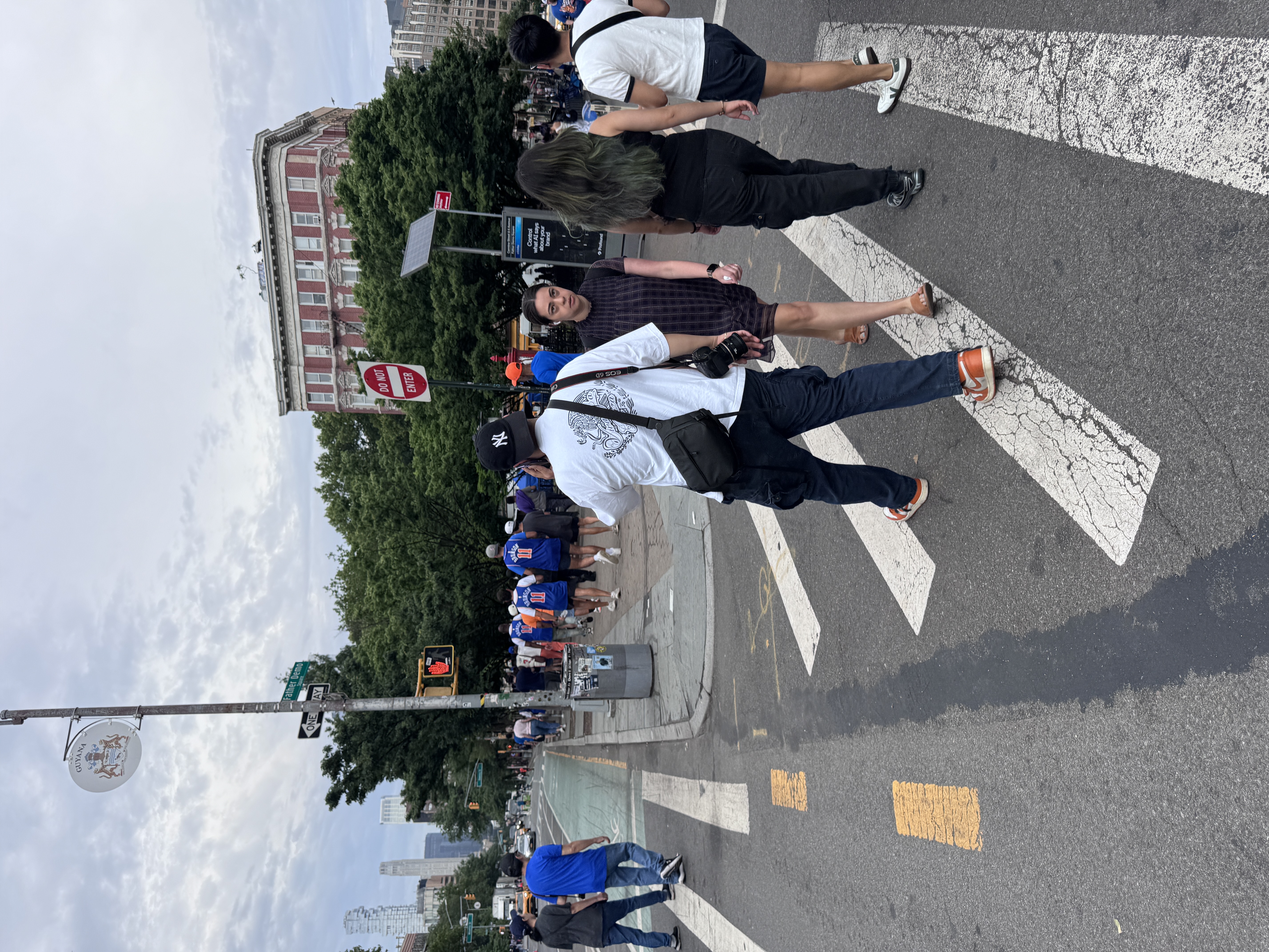 Parade goers walk down Sixth Avenue toward the Canyon of Heroes.