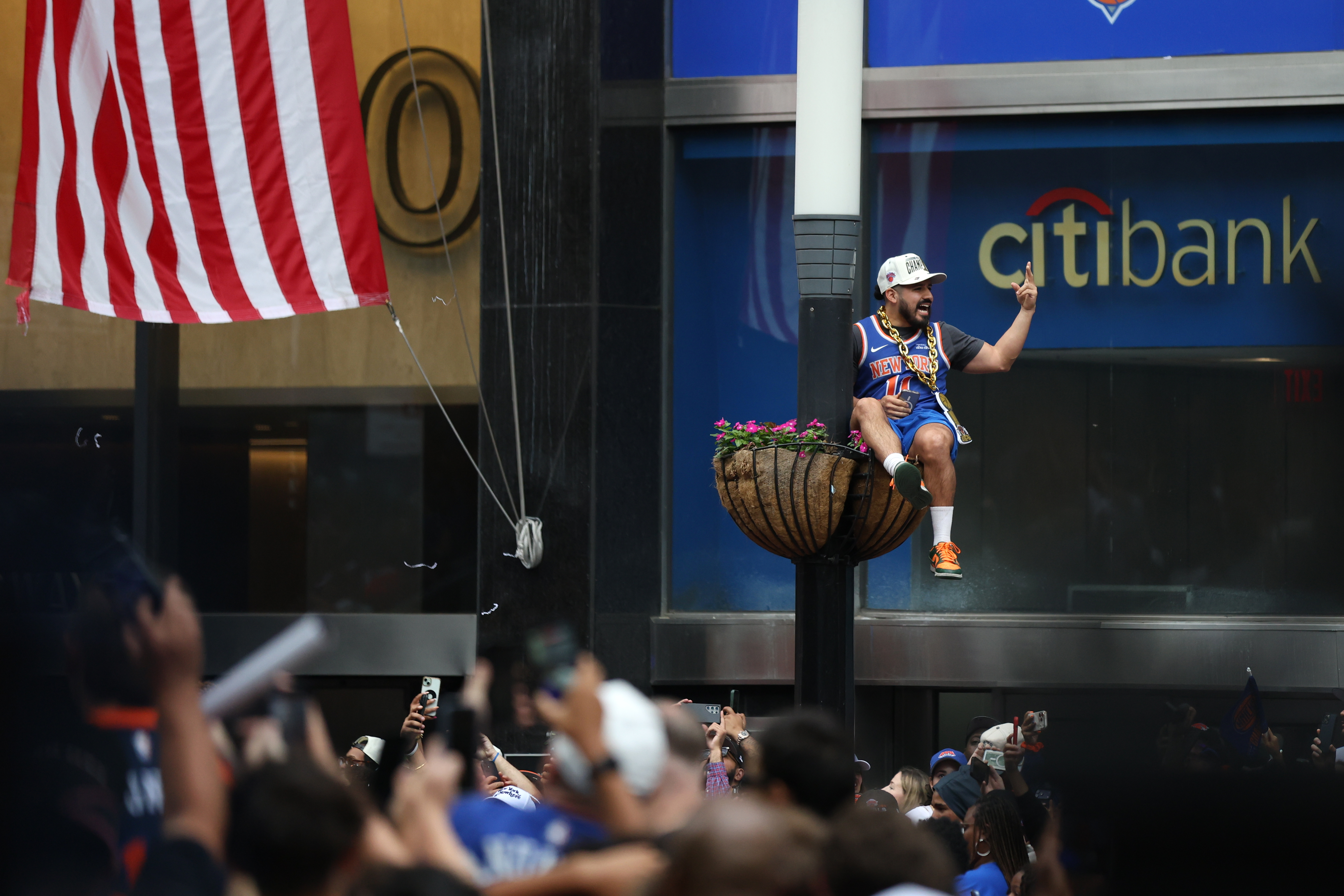 A fan watches during the New York Knicks' NBA championship parade Thursday, June 18, 2026, in New York.