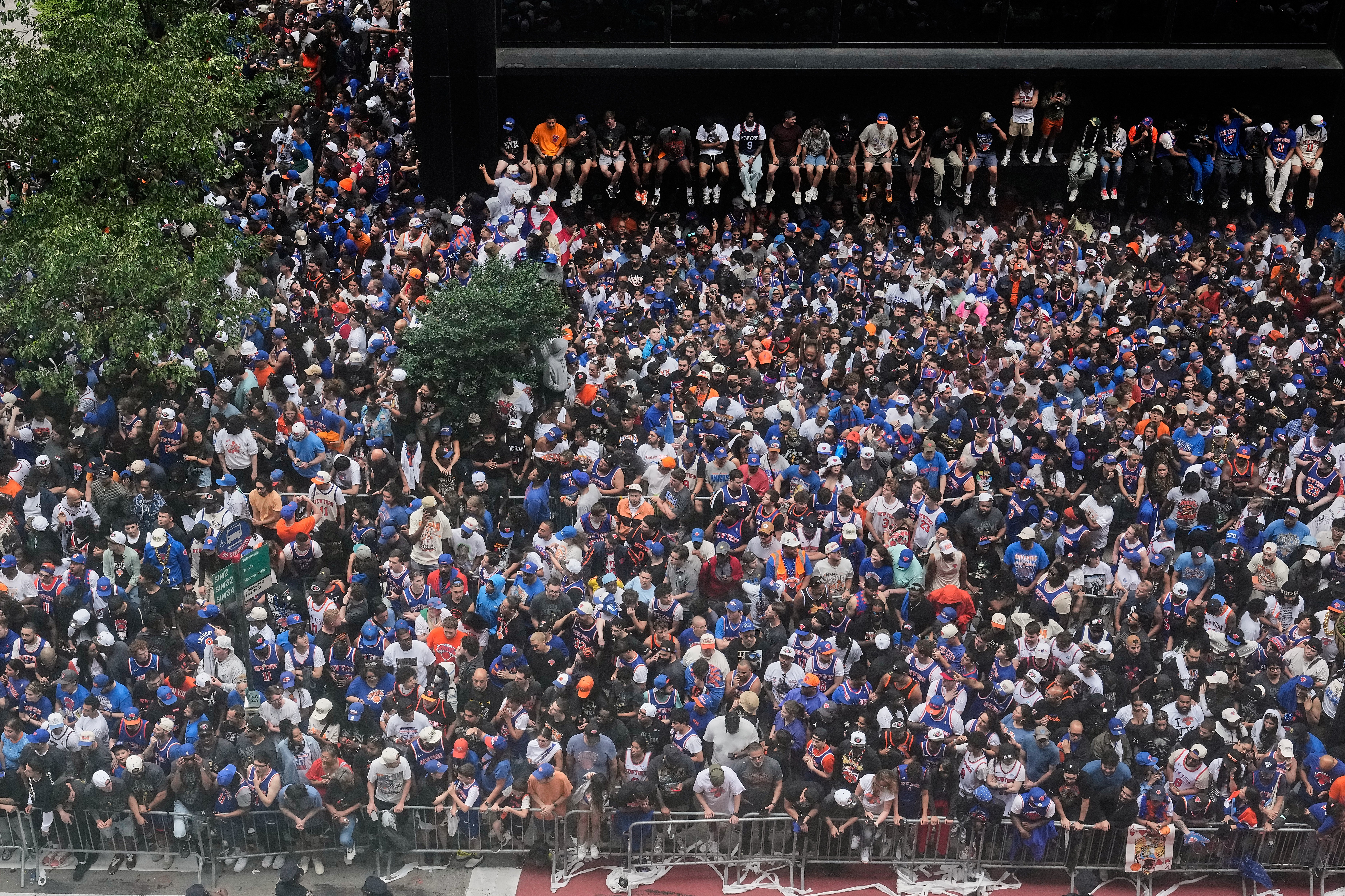 Crowds fill the sidewalks waiting for the start of the NBA Champion New York Knicks ticker-tape parade on Broadway, in New York's "Canyon of Heroes," Thursday, June 18, 2026.