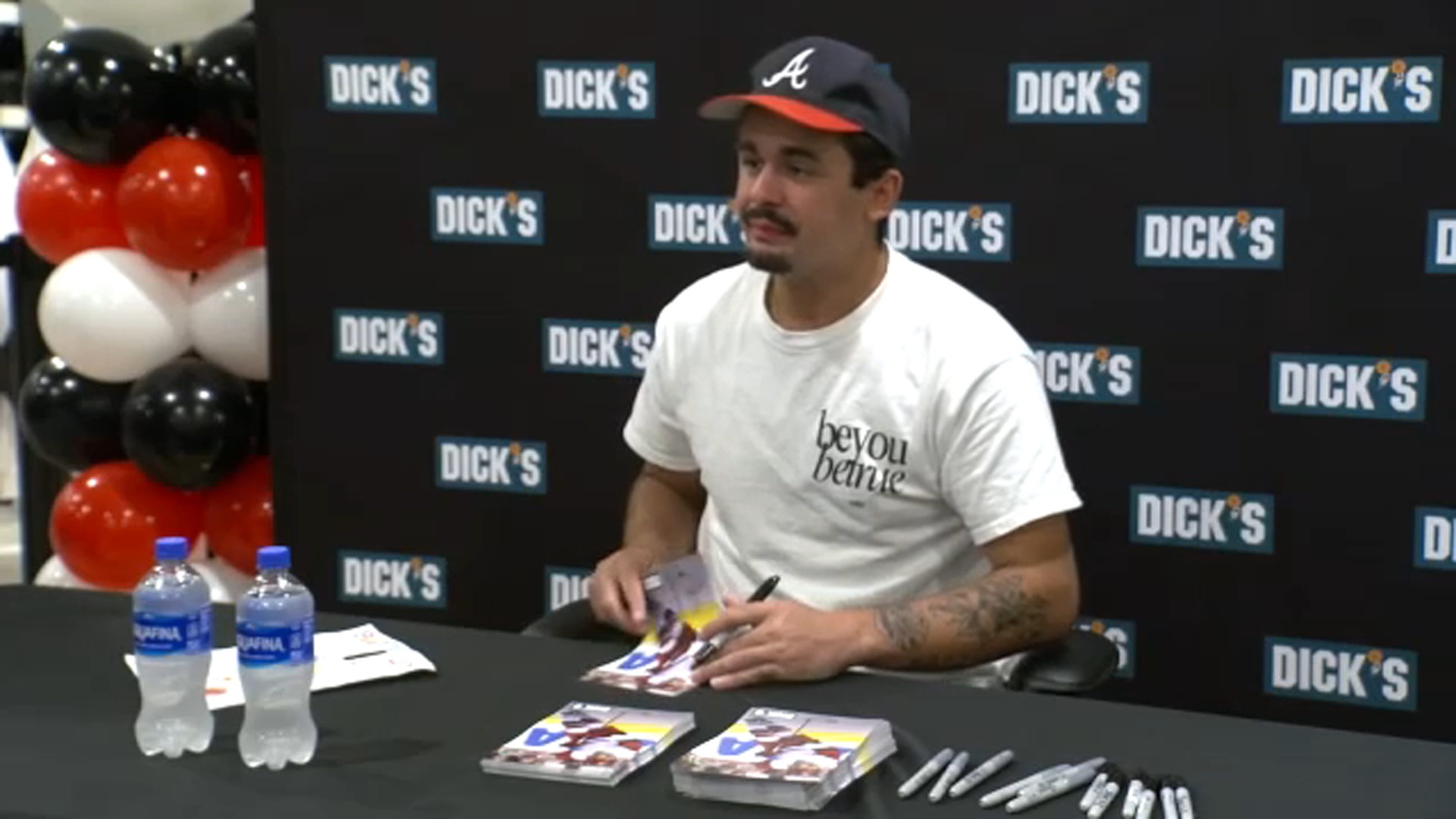 Hurricanes' Seth Jarvis signs autographs at Dick's Sporting Goods in Cary.
