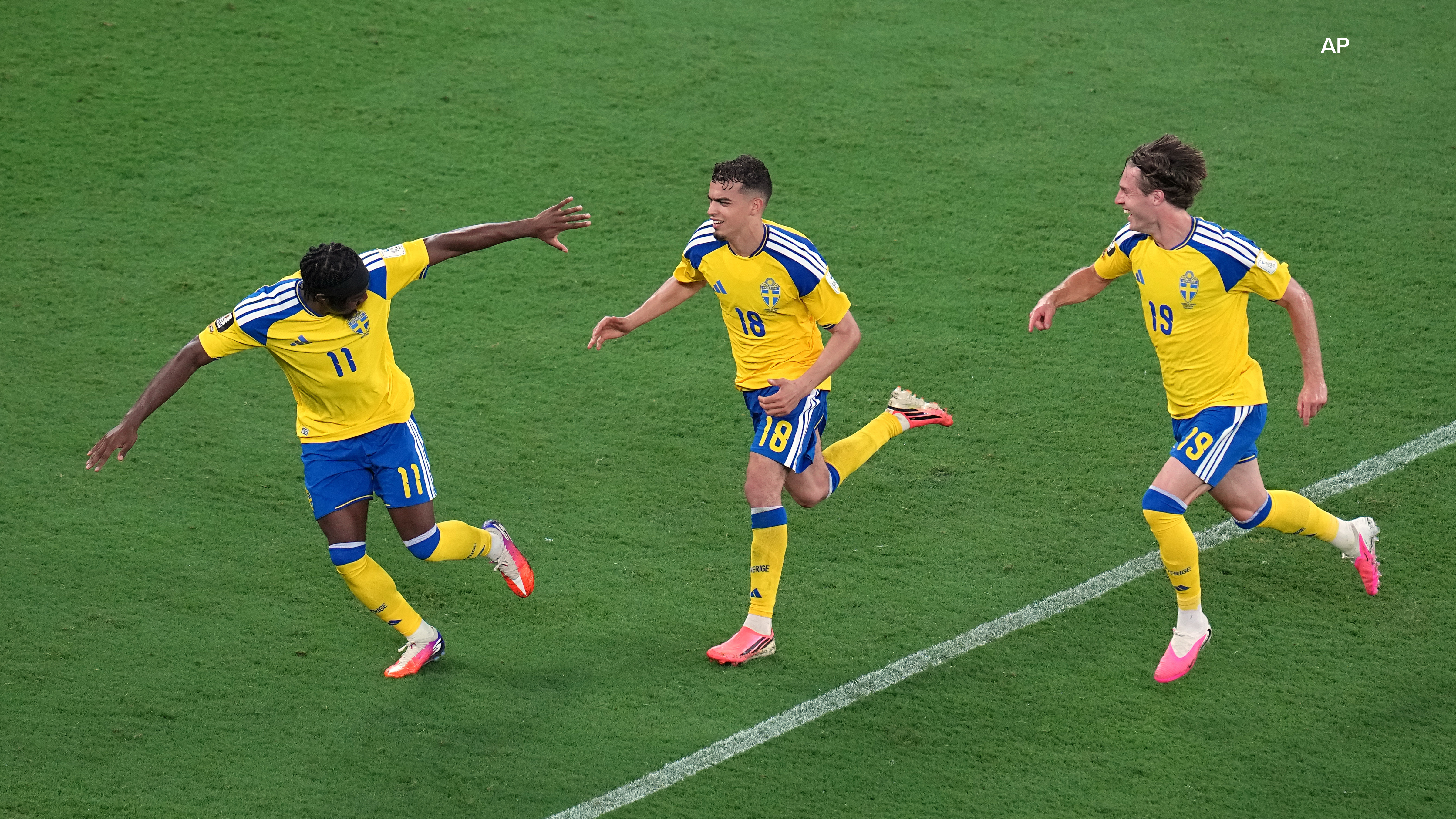 Sweden's Yasin Ayari (18) celebrates with Anthony Elanga (11) and Mattias Svanberg (19) after scoring their fifth goal during the World Cup Group F match. (AP Photo/Dolores Ochoa)