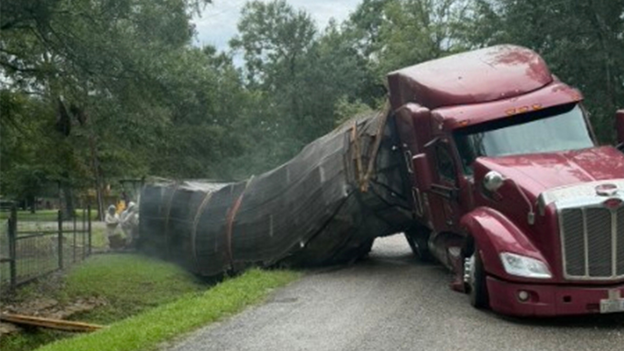 A semitrailer carrying about 400 beehives toppled over, allowing millions of bees to escape into a rural neighborhood in Orange, Texas, on June 21, 2026. 
