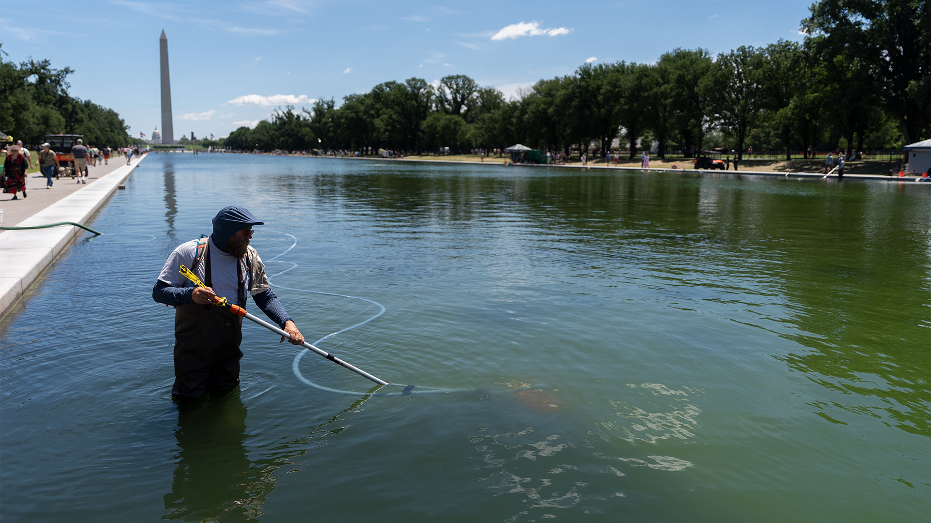 A National Park Service employee uses a vacuum to clean the Lincoln Memorial Reflecting Pool, Saturday, June 20, 2026, in Washington.